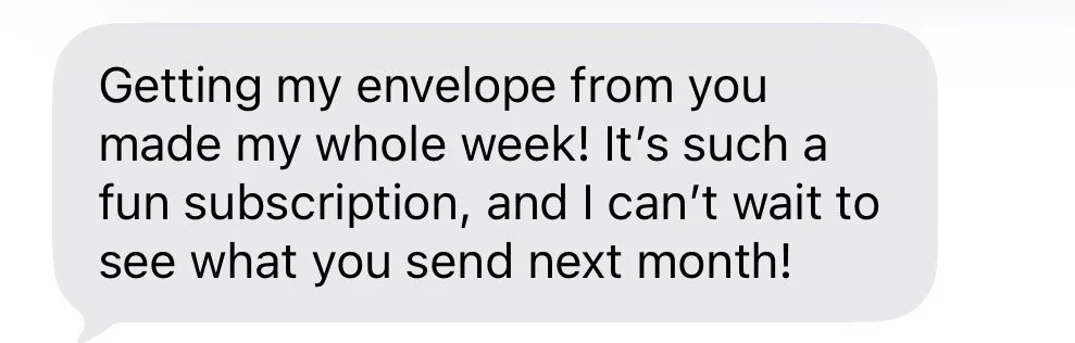 A screenshot of a text message conversation with a gray speech bubble containing the message: "Getting my envelope from you made my whole week! It’s such a fun subscription, and I can’t wait to see what you send next month!"
