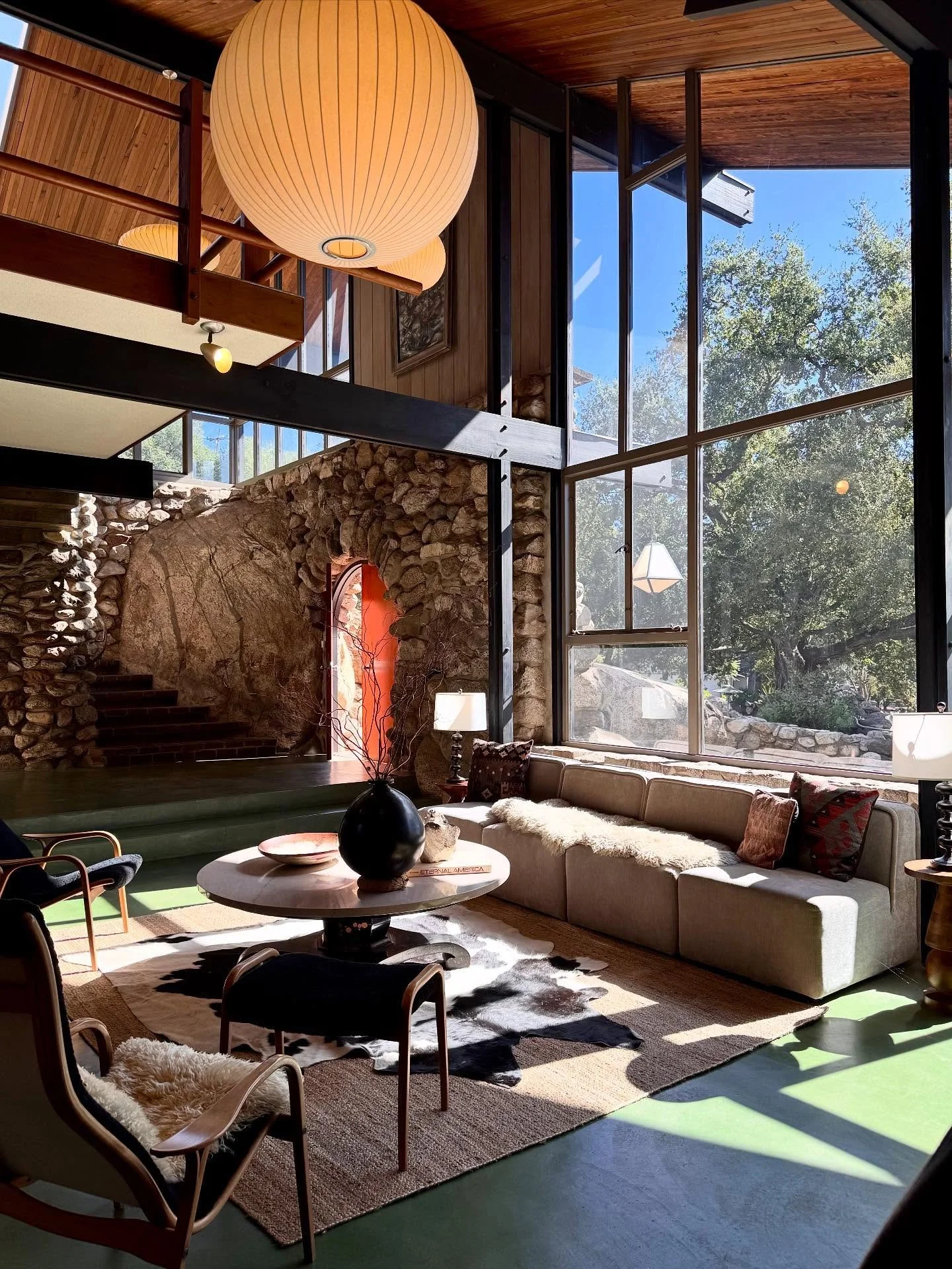 A stone-built architectural landmark in the oaks of Altadena 🌄

✔️ Historic 1912 stone home blending Arts &amp; Crafts warmth with mid-century modern design 

✔️ I ❤️ the redwood paneling, beamed ceilings, and step-down living room anchored by a mas