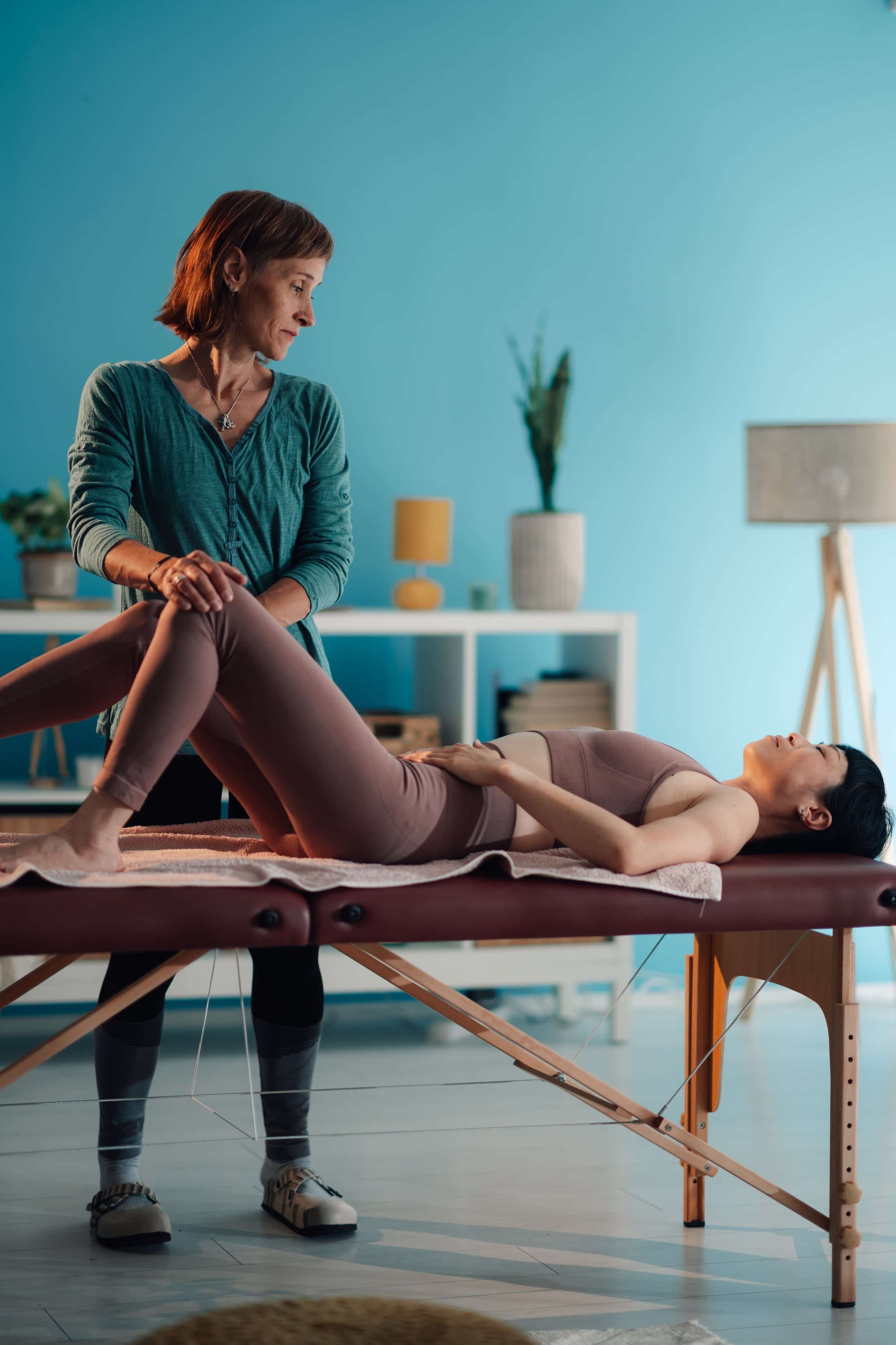 Woman laying on table receiving physical therapy