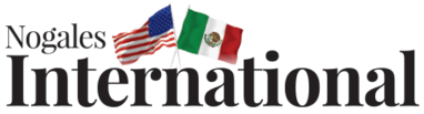 Nogales International logo with American and Mexican flags above the text.