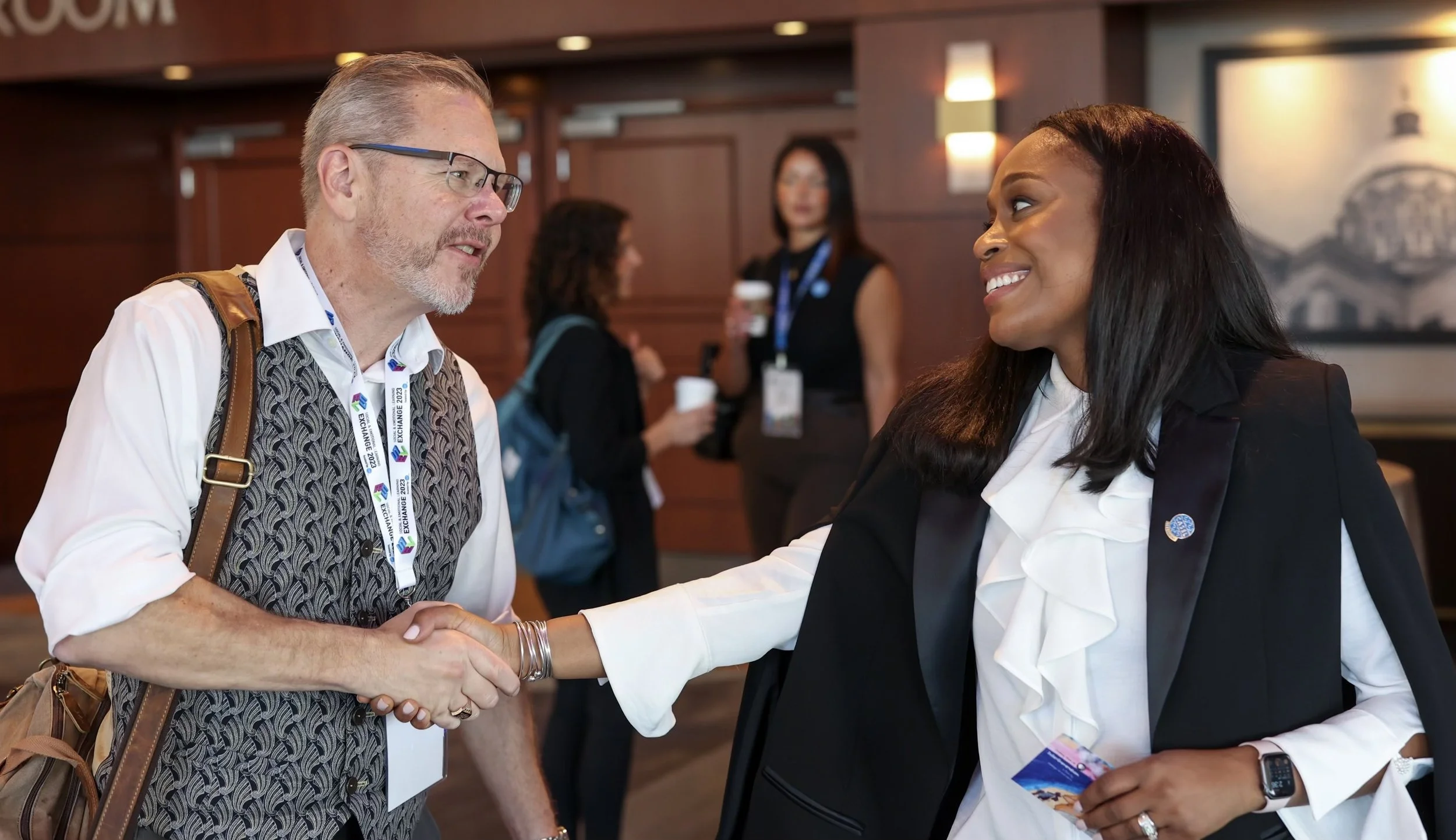 Dr. Samuel greeting guests at an international conference. 
