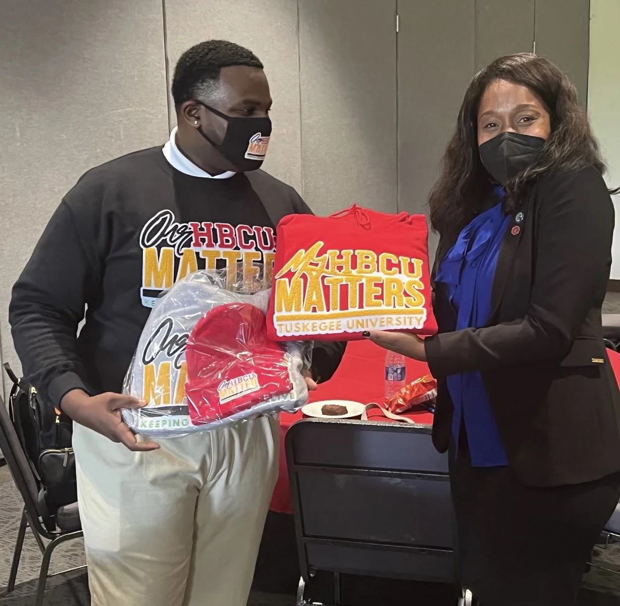 At an HBCU roundtable on pandemic recovery, a student leader presents Dr. Aaliyah Samuel with a sweatshirt honoring her alma mater—an intergenerational moment rooted in resilience, leadership, and the enduring legacy of HBCUs.
