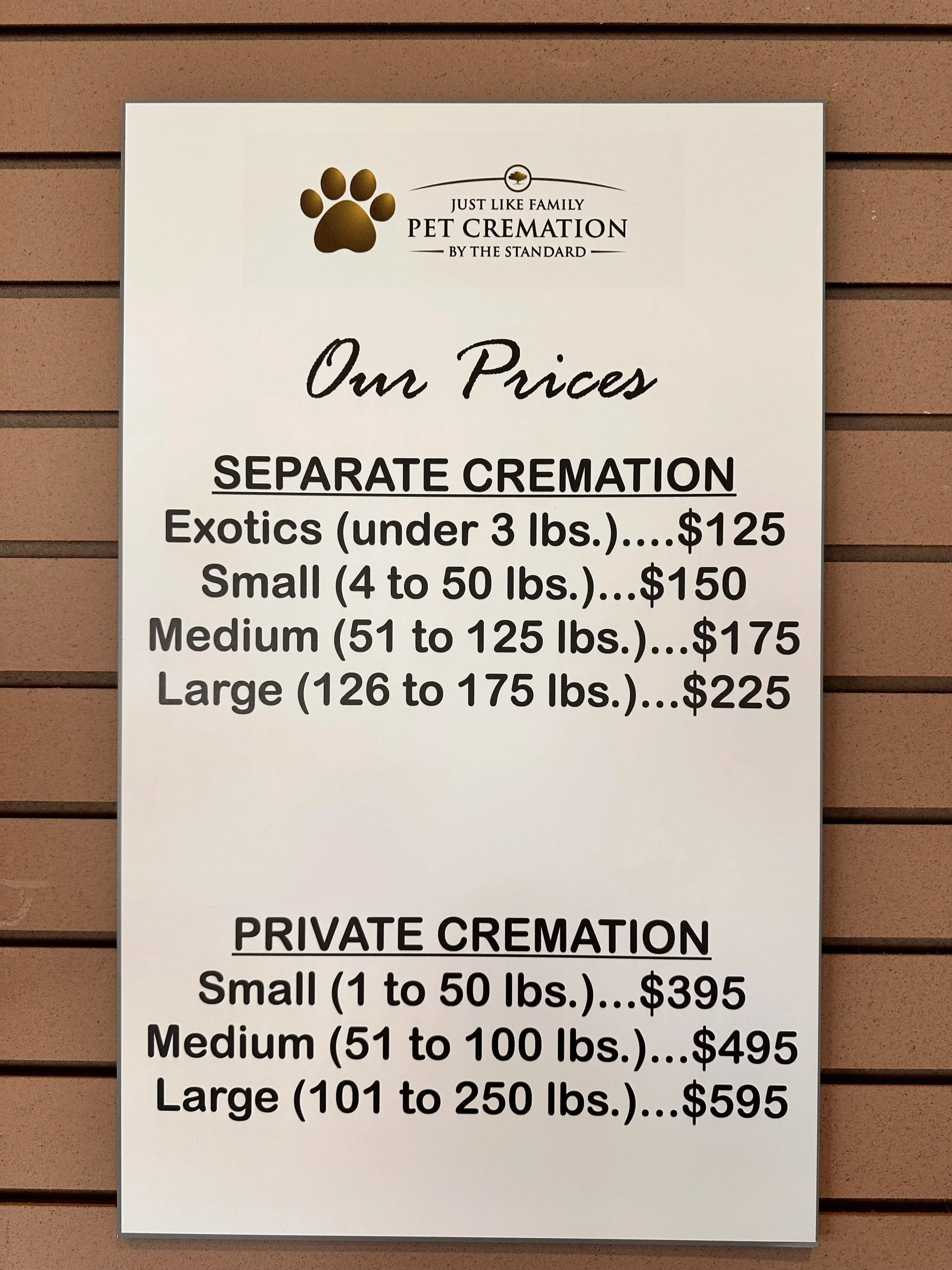 Sign listing prices for pet cremation services based on pet size, with prices ranging from $125 for under 3 lbs to $595 for pets 101 to 250 lbs.