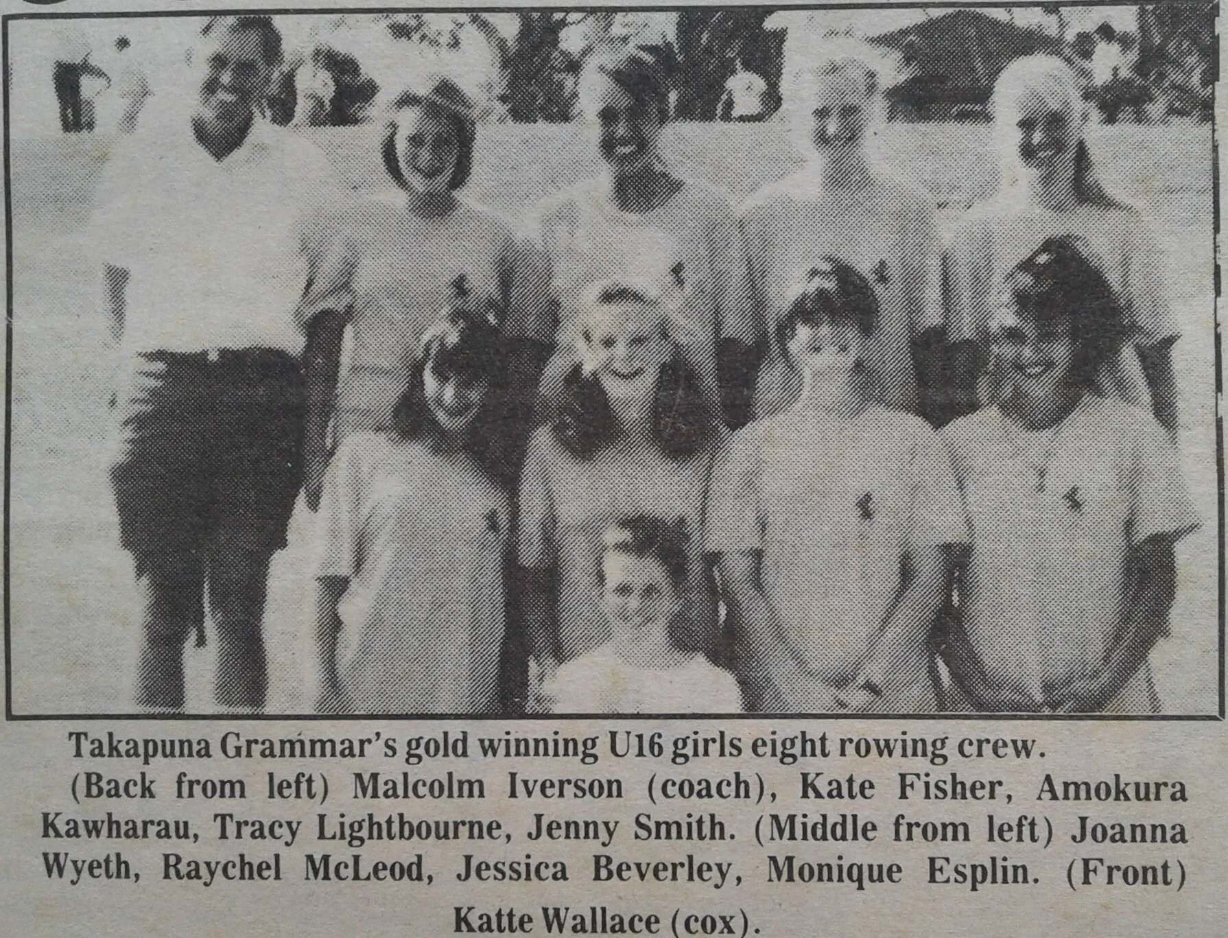 A black and white photo of a girls' rowing team with nine women, some in their twenties and some young girls, wearing matching sports uniforms. The team is outdoors on a grassy field. The caption identifies the team as Takapuna Grammar's gold-winning U16 girls eight rowing crew, with coach Malcolm Iverson and team members Kate Fisher, Amokura Kawharau, Tracy Lightbourne, Jenny Smith, Joanna Wyeth, Raychel McLeod, Jessica Beverley, and Monique Esplin. Katte Wallace is noted as the cox.