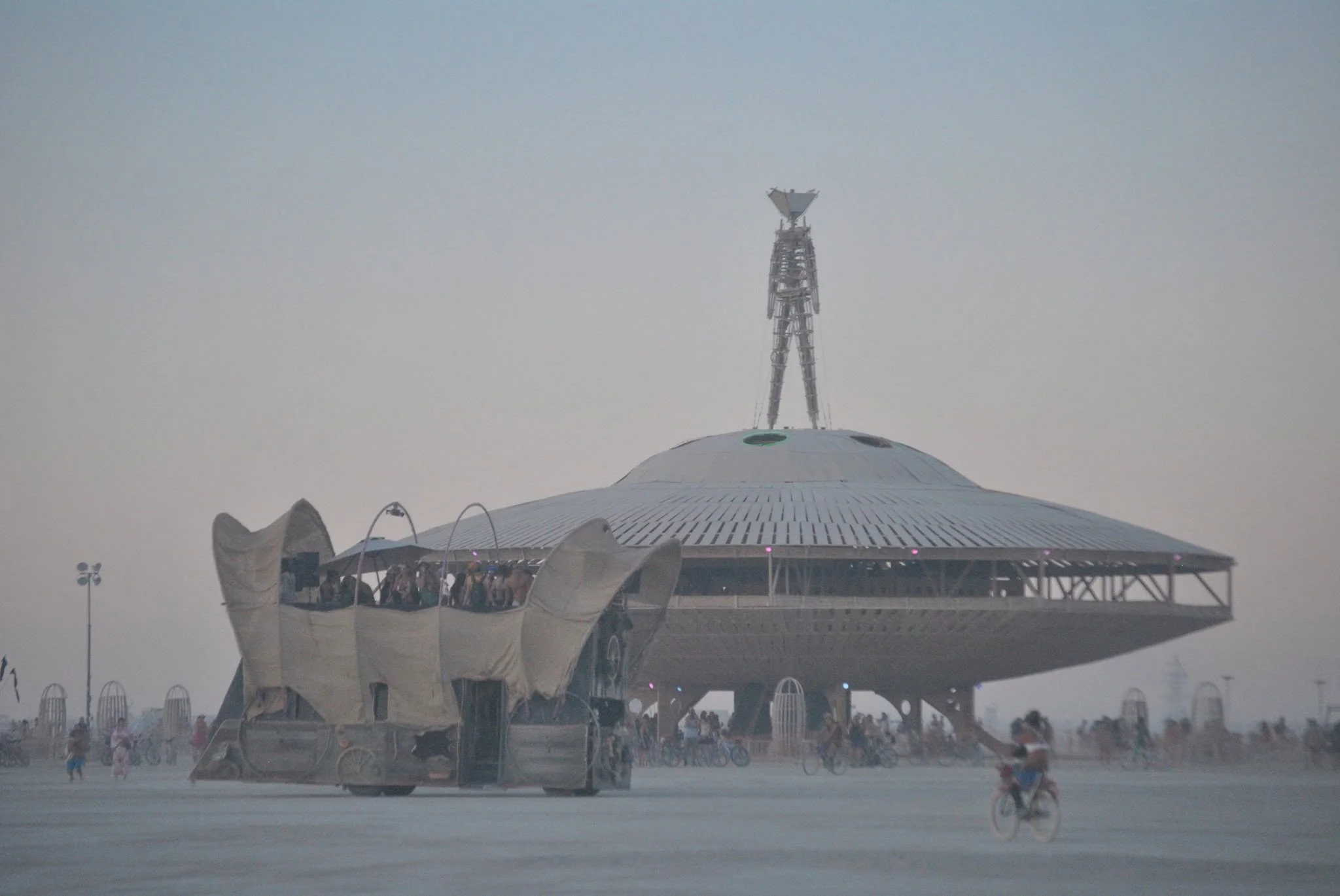 The Man stands atop the giant flying saucer during Burning Man 2013: Cargo Cult.