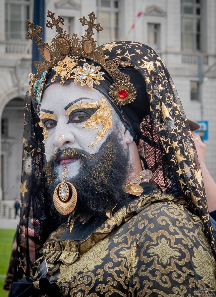 Sister of Perpetual Indulgence in ornate black and gold costume and white face makeup in San Francisco.