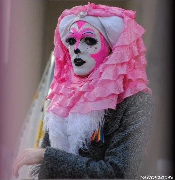 Sister of Perpetual Indulgence wearing an elaborate pink habit and theatrical makeup in San Francisco.