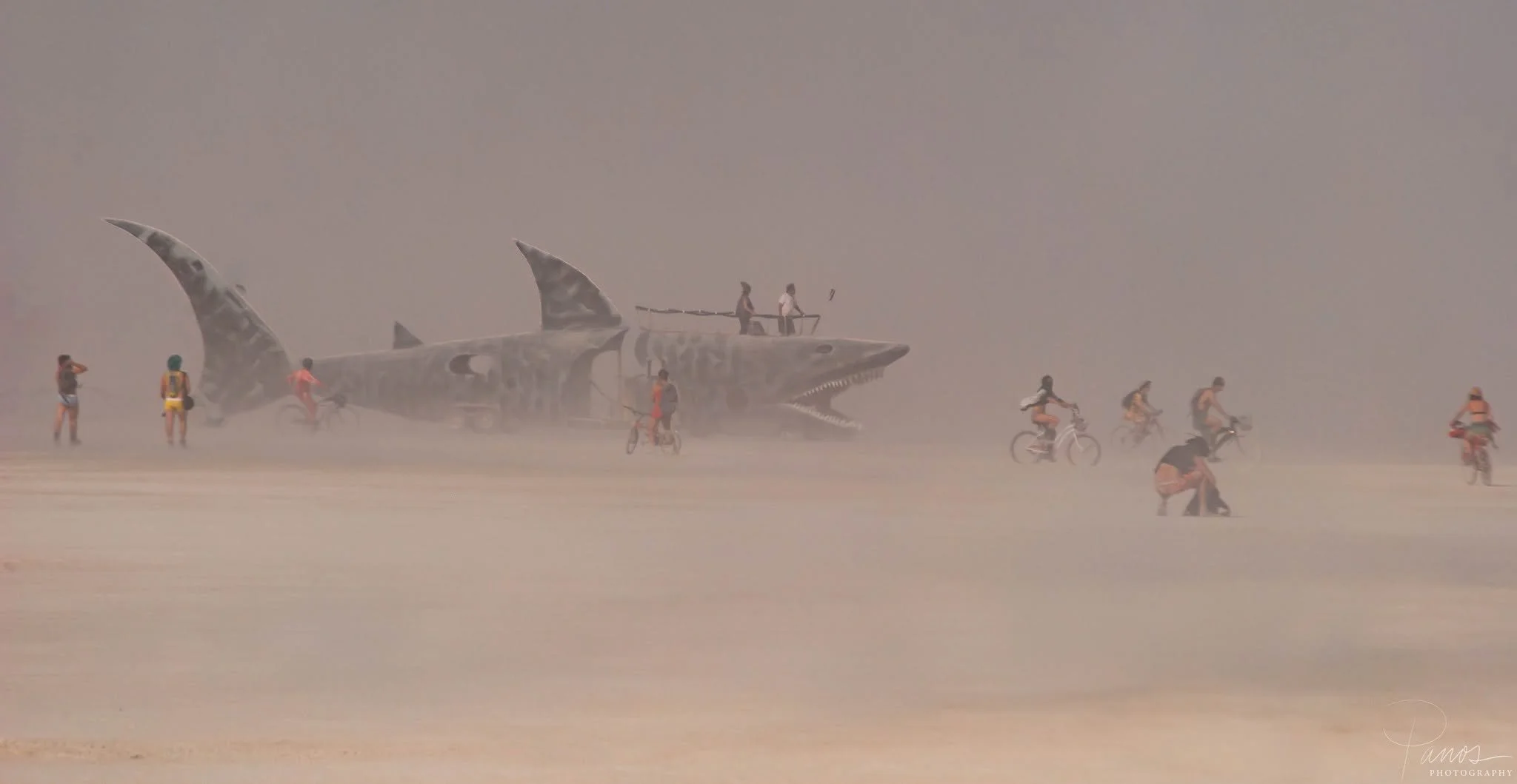 Giant shark Mutant Vehicle crosses the dusty playa at Burning Man 2013.
