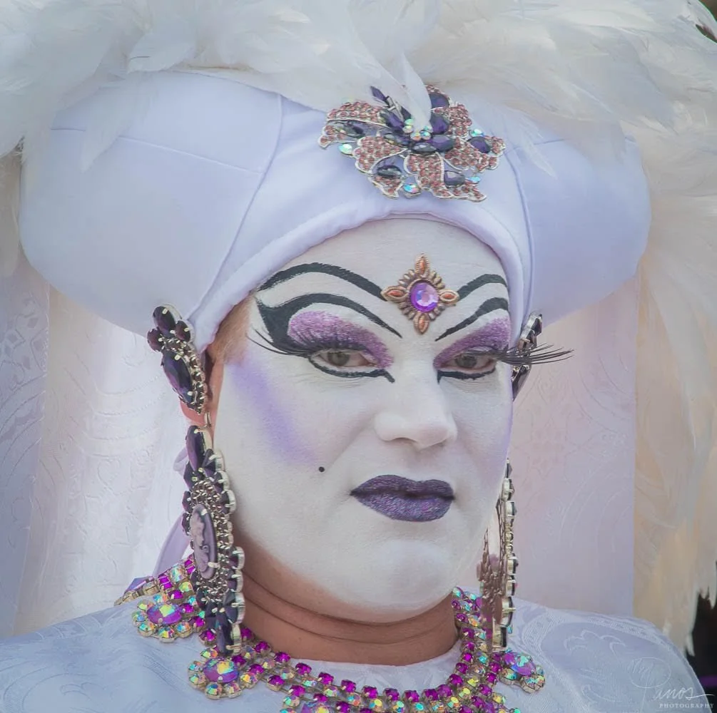 Sister of Perpetual Indulgence wearing a jeweled white headdress and dramatic makeup in San Francisco.