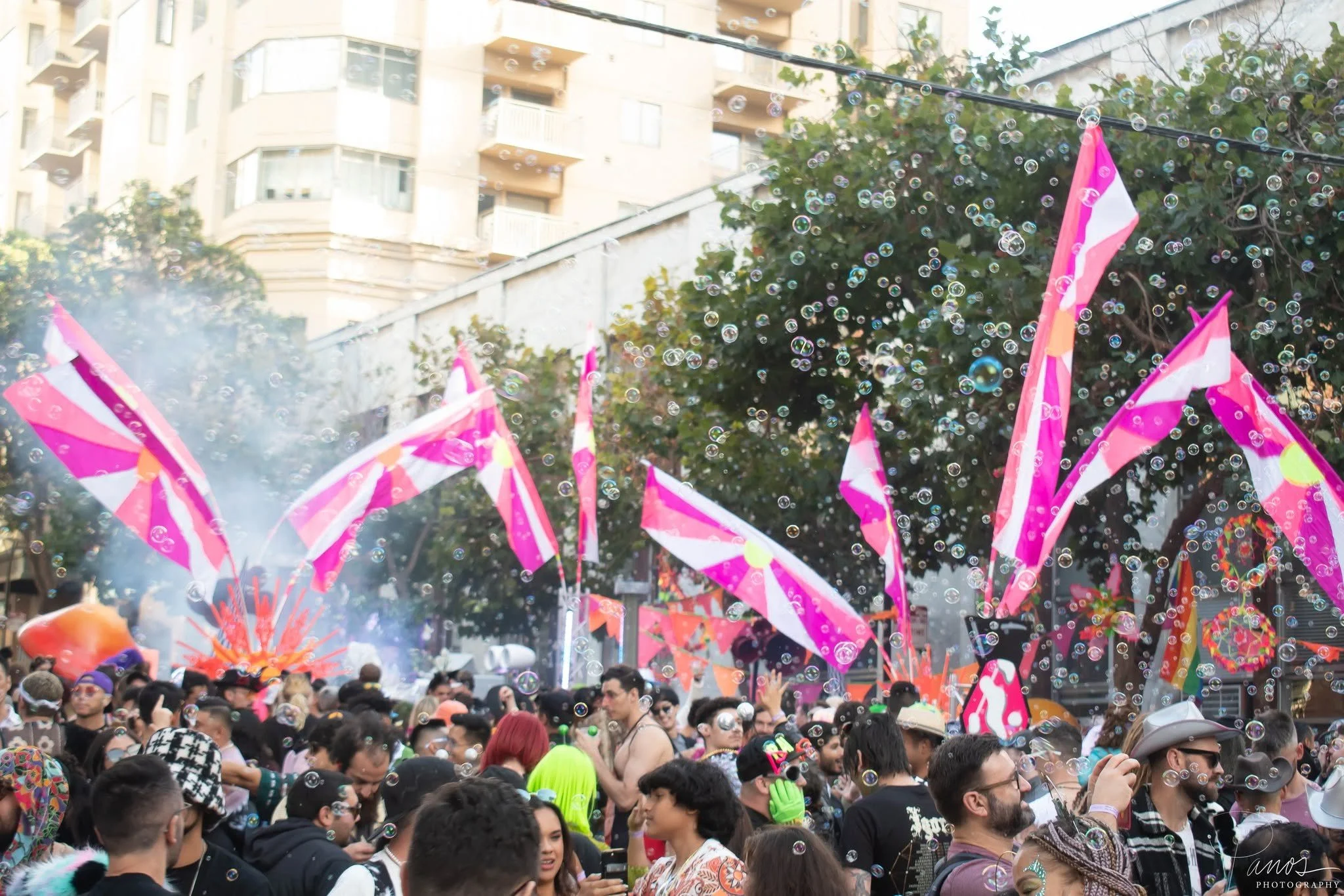 olorful flags, bubbles and festivalgoers fill the street during the How Weird Street Faire in San Francisco.