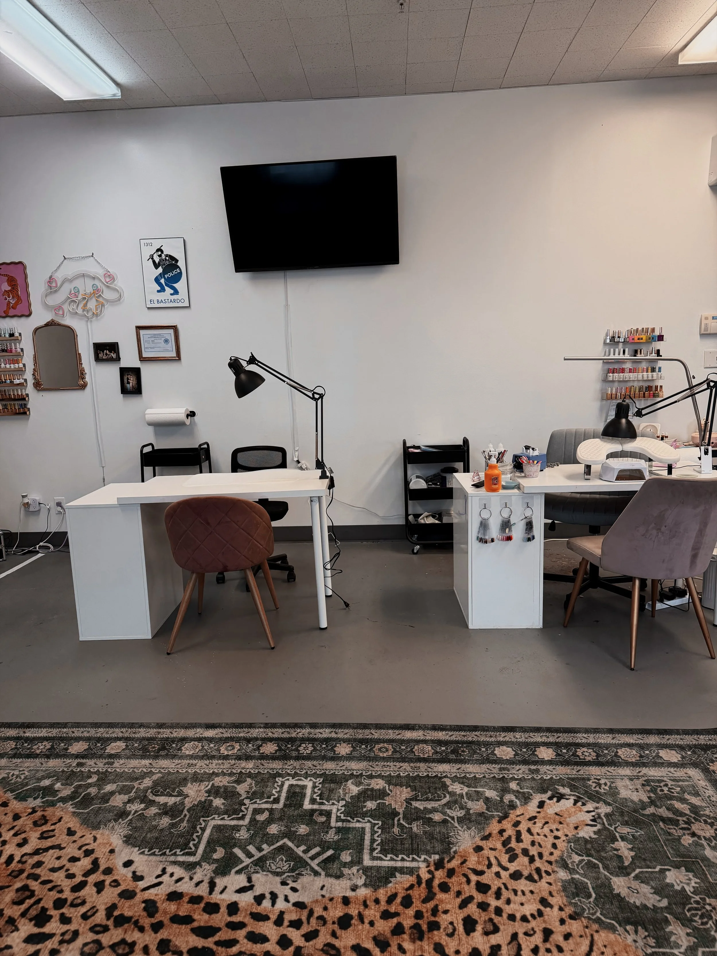 Nail artist station with wall-mounted gel polish collection inside Pinché Collective in South Salt Lake.
