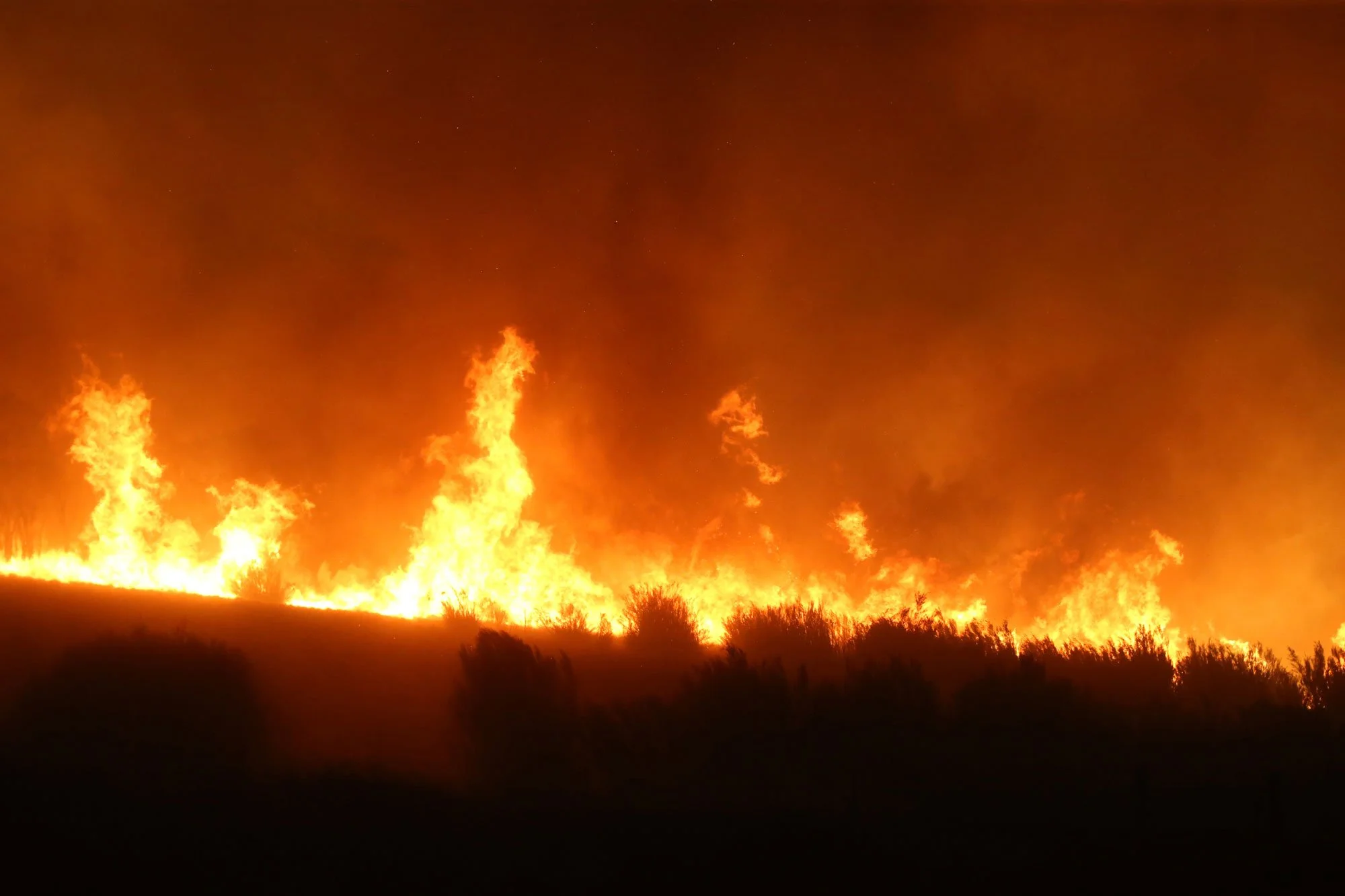  The fire closes in on the property from all sides as spot fires ignite a 360 degree fire front as Fire approaches from the south at Tallabrook lodge a property along the Bumbalong Road North of Bredbo.   Saturday 1st February 2020. Guardian Australi
