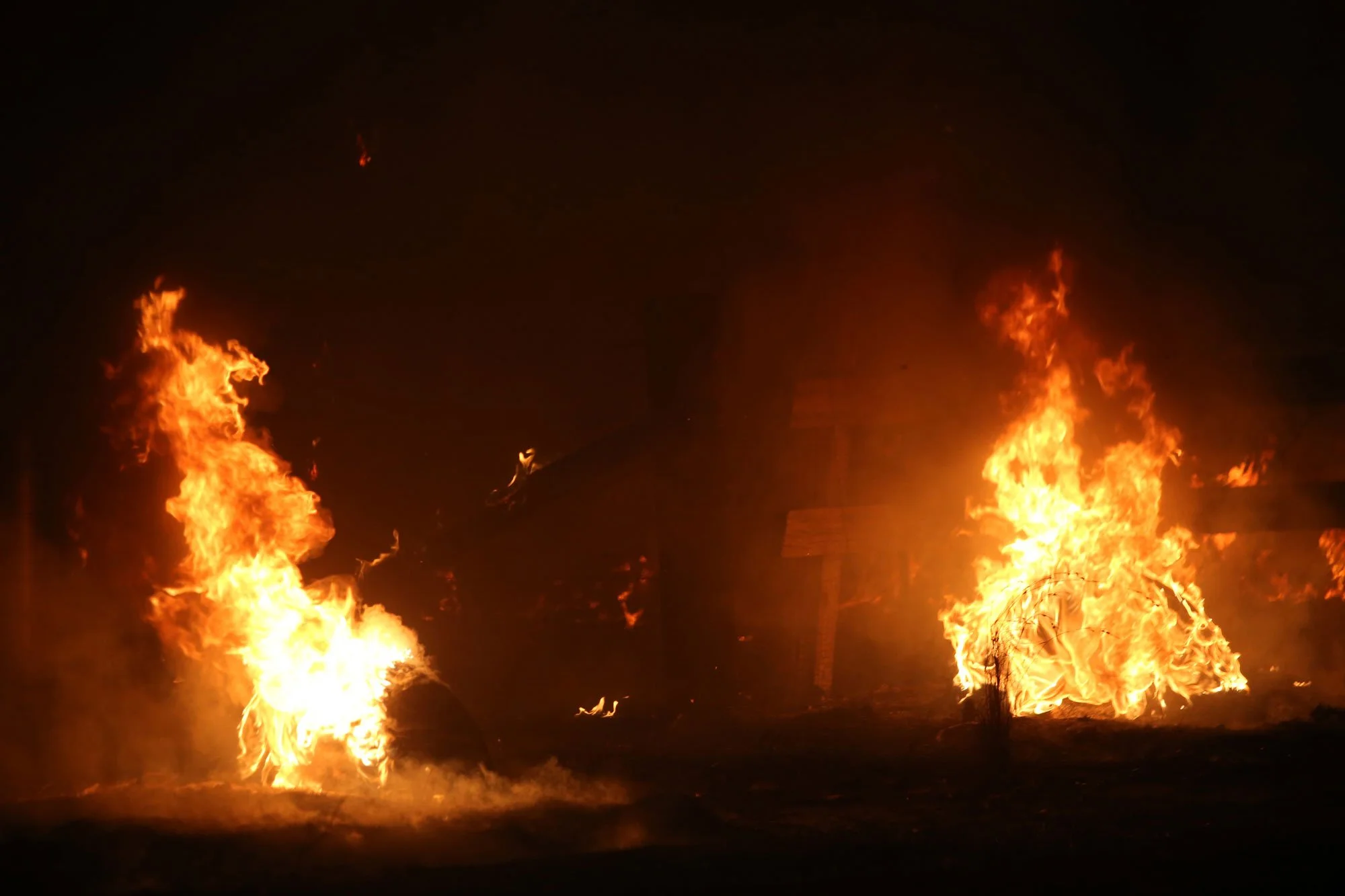  The Bushfire turned night to day as Flames burn two tires that mark a driveway on the Sussex Inlet road a few kilomteres from the princes highway intersection south of Nowra this afternoon.   Tuesday 31st December 2019. Guardian Australia. 