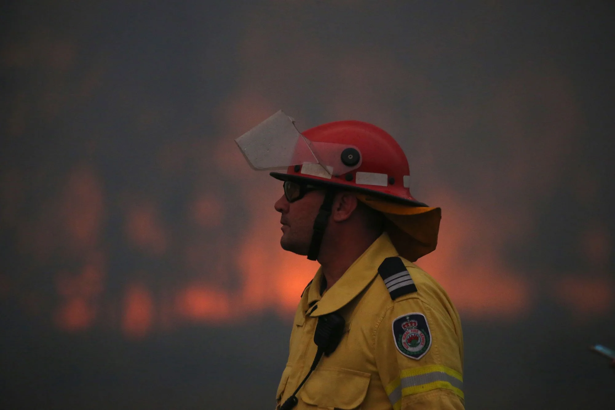  Horsley Park RFS Crew. The captain of Horsley Park Darren Nation watches the fire front advance towards Potato Point on NSW South Coast.   Thursday 23rd January 2020. Guardian Australia. 