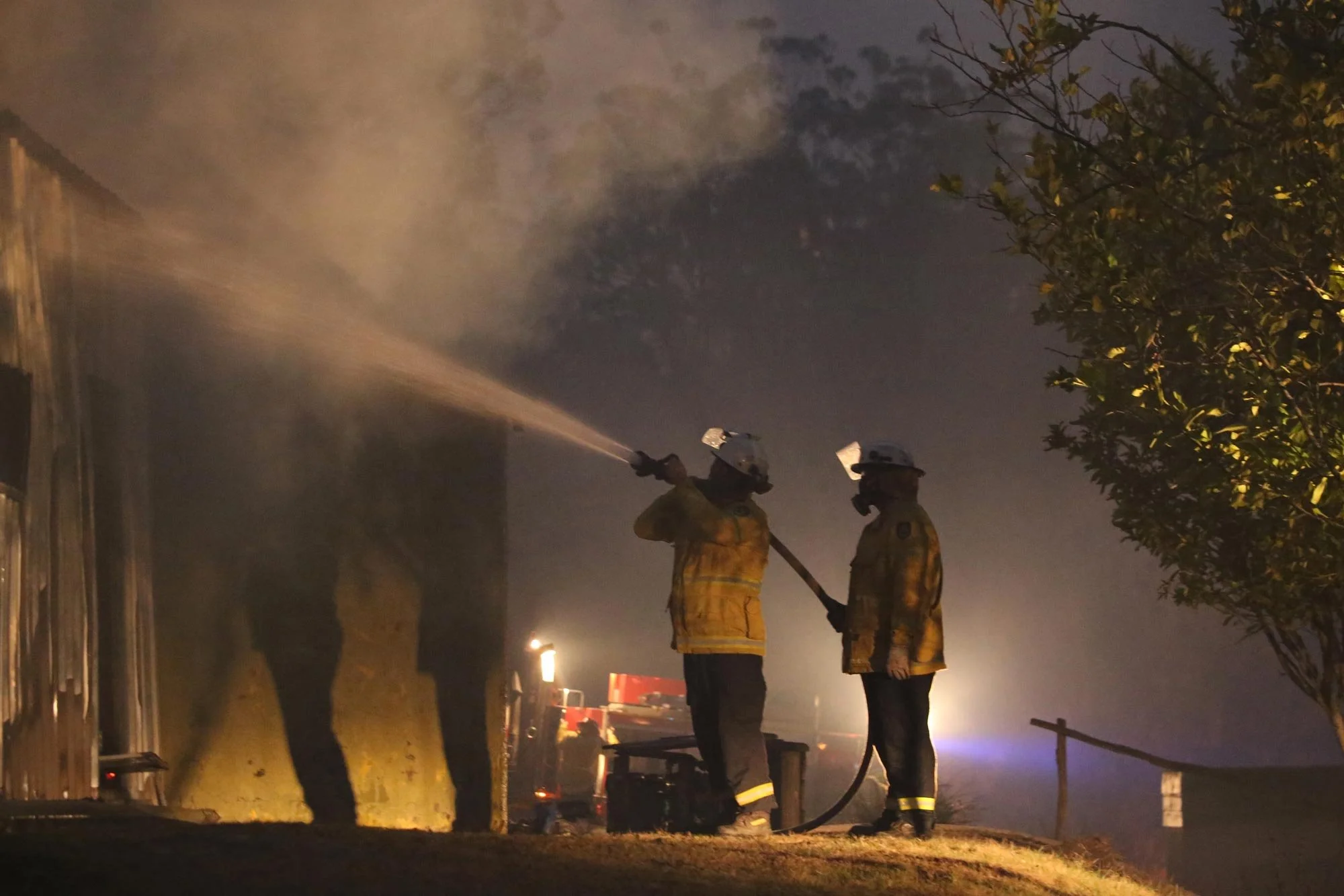 Horsley Park RFS Crew extinguish a fire in a garage which was well alight when they arrived on a property near Potato Point on NSW South Coast.   Thursday 23rd January 2020. Guardian Australia. 