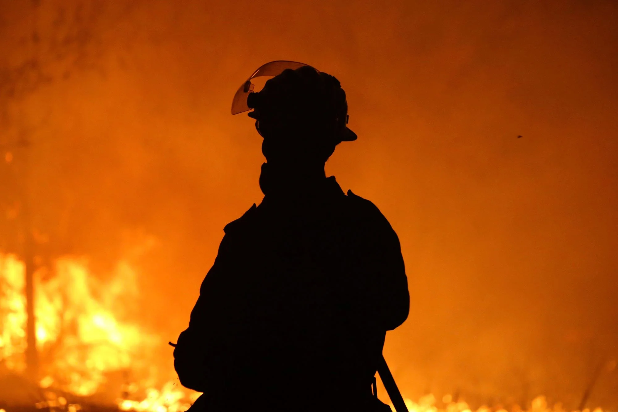  Horsley Park RFS Crew. Horsley Park fire fighter Daniel Knox defends a property near Potato Point on NSW South Coast.   Thursday 23rd January 2020. Guardian Australia. 