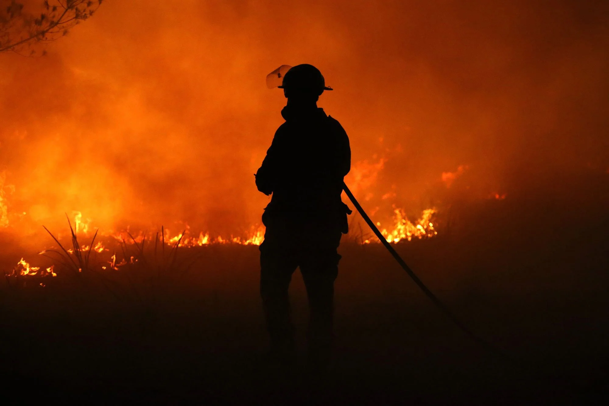  Horsley Park RFS Crew. Horsley Park fire fighter Daniel Knox defends a property near Potato Point on NSW South Coast.   Thursday 23rd January 2020. Guardian Australia. 
