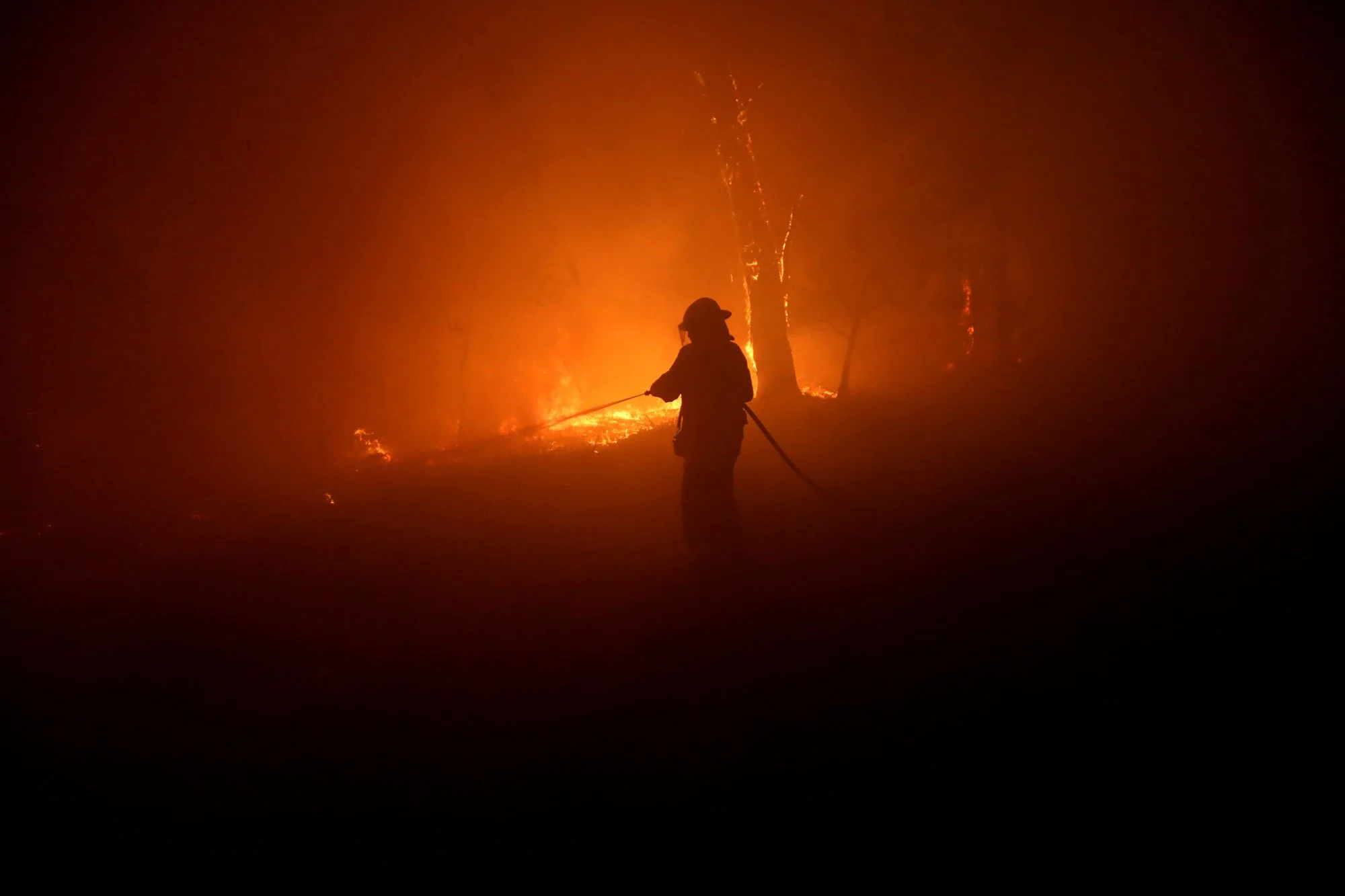  Horsley Park RFS Crew. The captain of Horsley Park Darren Nation defends a property near Potato Point on NSW South Coast.   Thursday 23rd January 2020. Guardian Australia. 