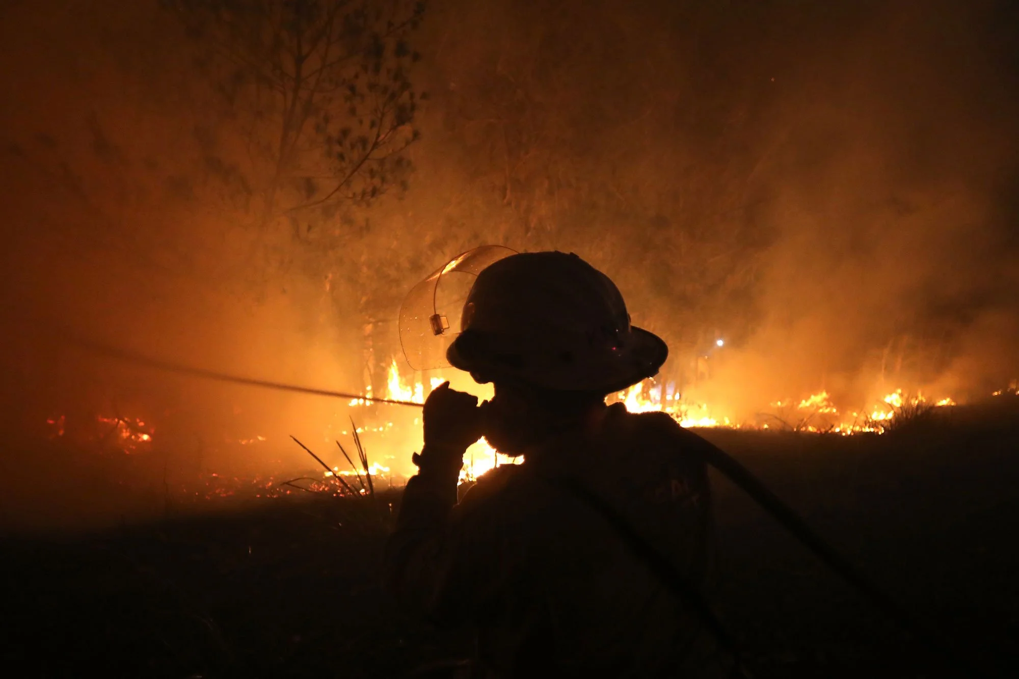  Horsley Park RFS Crew. RFS firefighter Daniel Knox defends a property near Potato Point on NSW South Coast.   Thursday 23rd January 2020. Guardian Australia. 