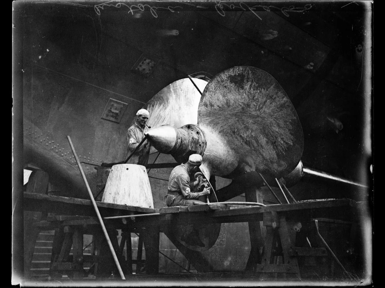 Fairfax Corporation, Men working on the propeller of the H.M.A.S. Australia at Cockatoo Island Dock, Sydney 4 June 1930, nla.gov.au/nla.obj-161678472