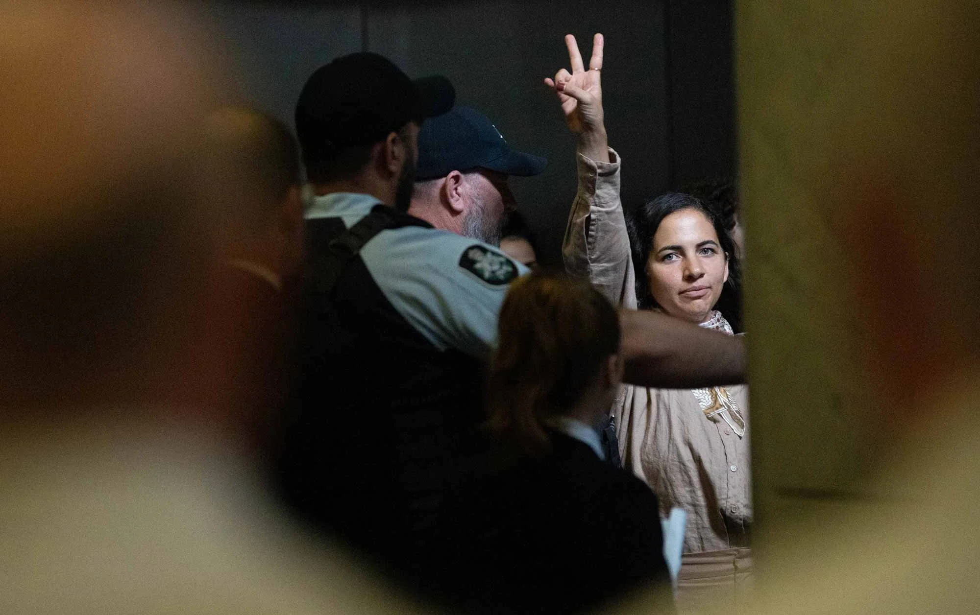 Police remove an anti-genocide protestor after they disrupted the House of Representatives. 