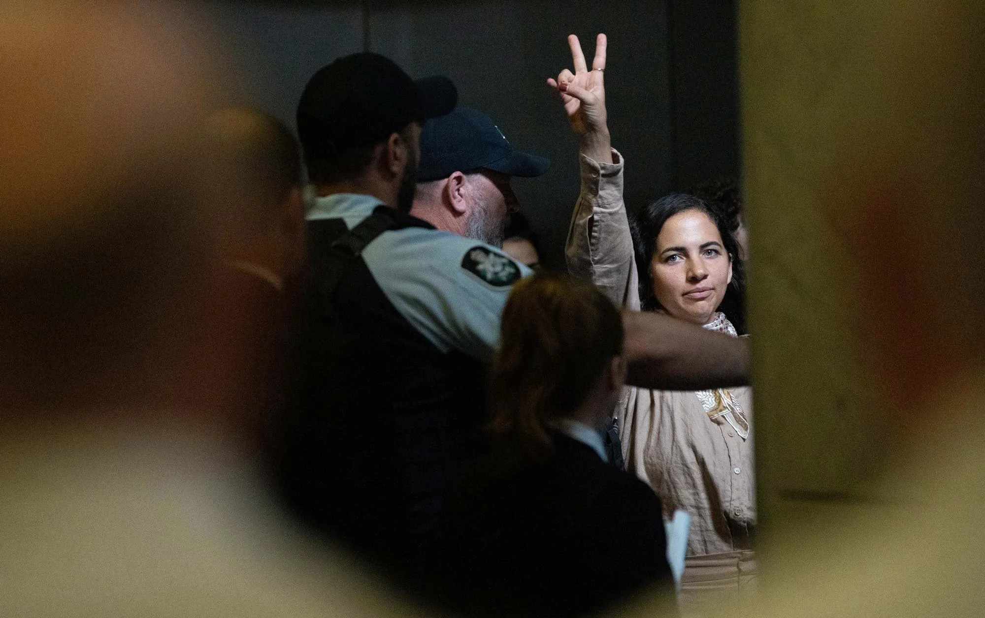 Police remove an anti-genocide protestor after they disrupted the House of Representatives. 