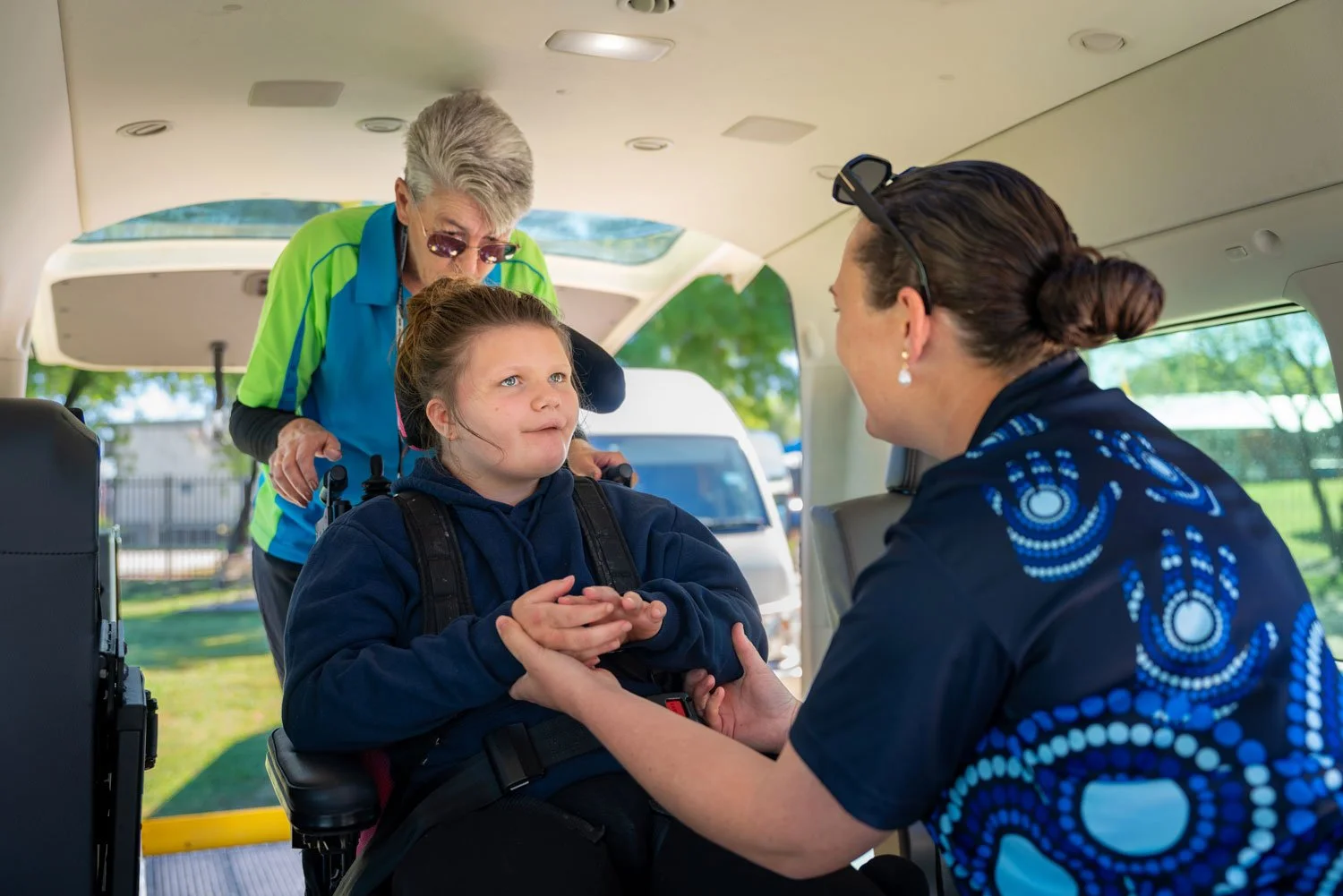 Suppoya staff helping a student with a disability get to school