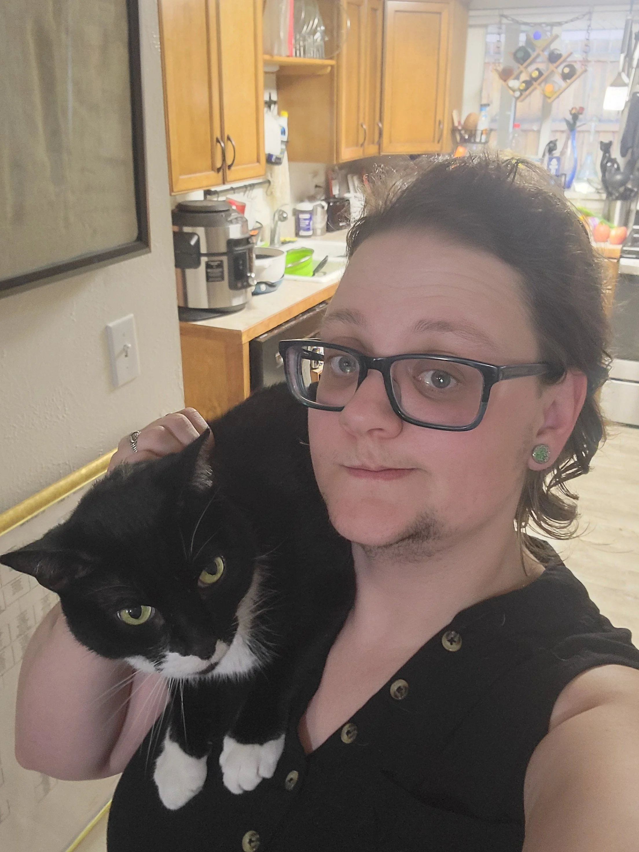 Music Robeson with a cat on their shoulder