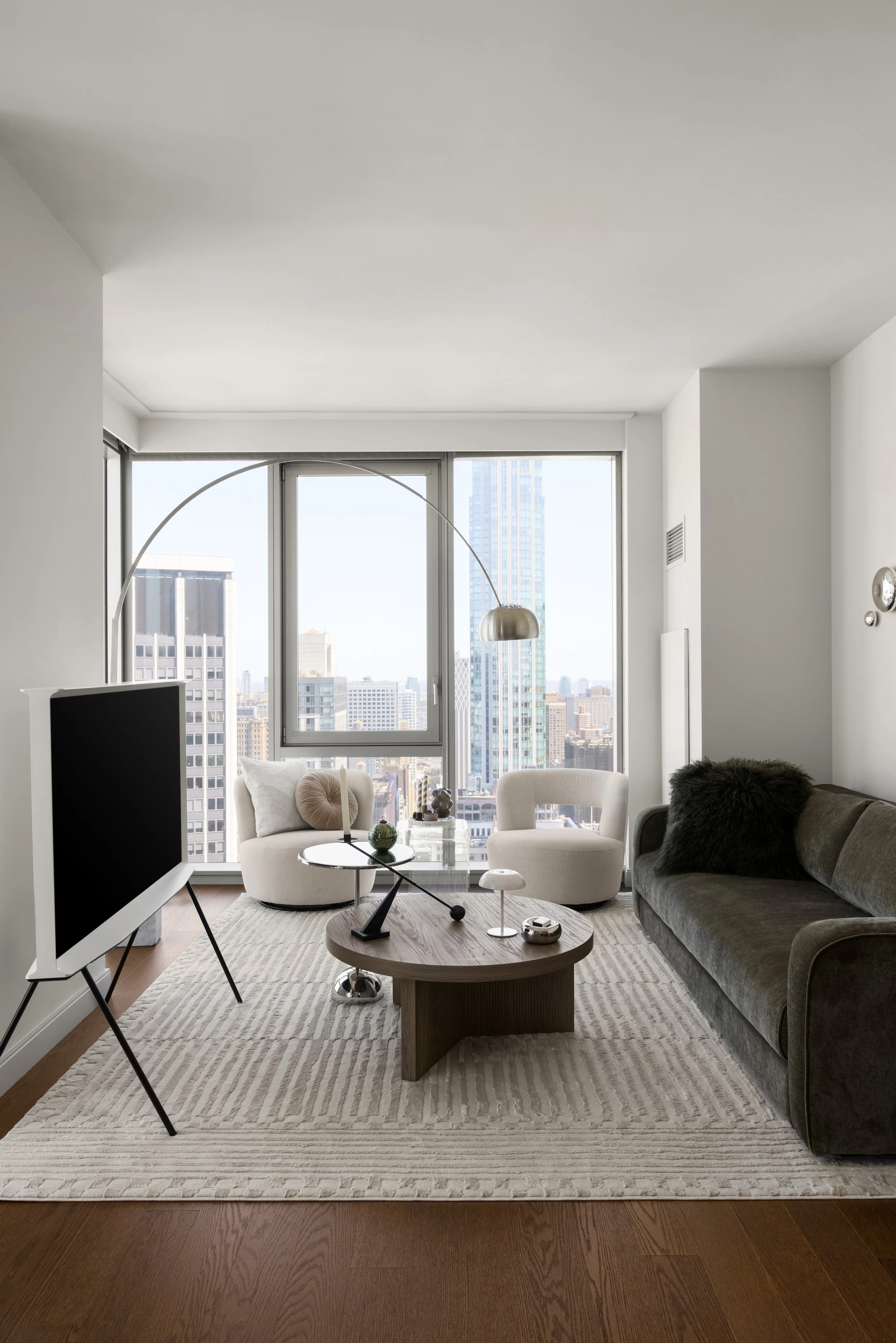 Designer NoMad apartment living room with skyline backdrop, layered materials, and calm contemporary interiors