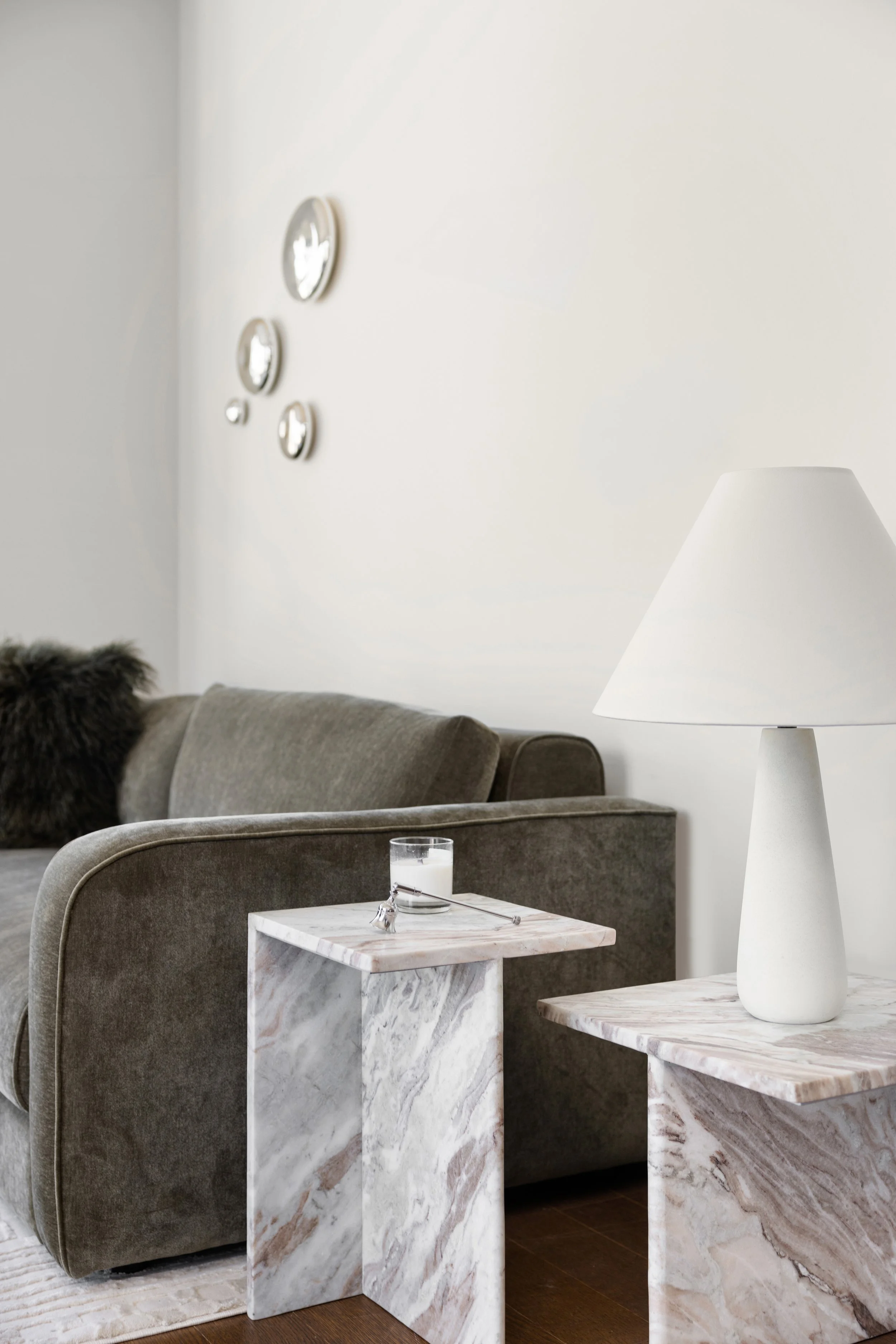 New York City apartment living space with custom styling, warm wood floors, and panoramic city views