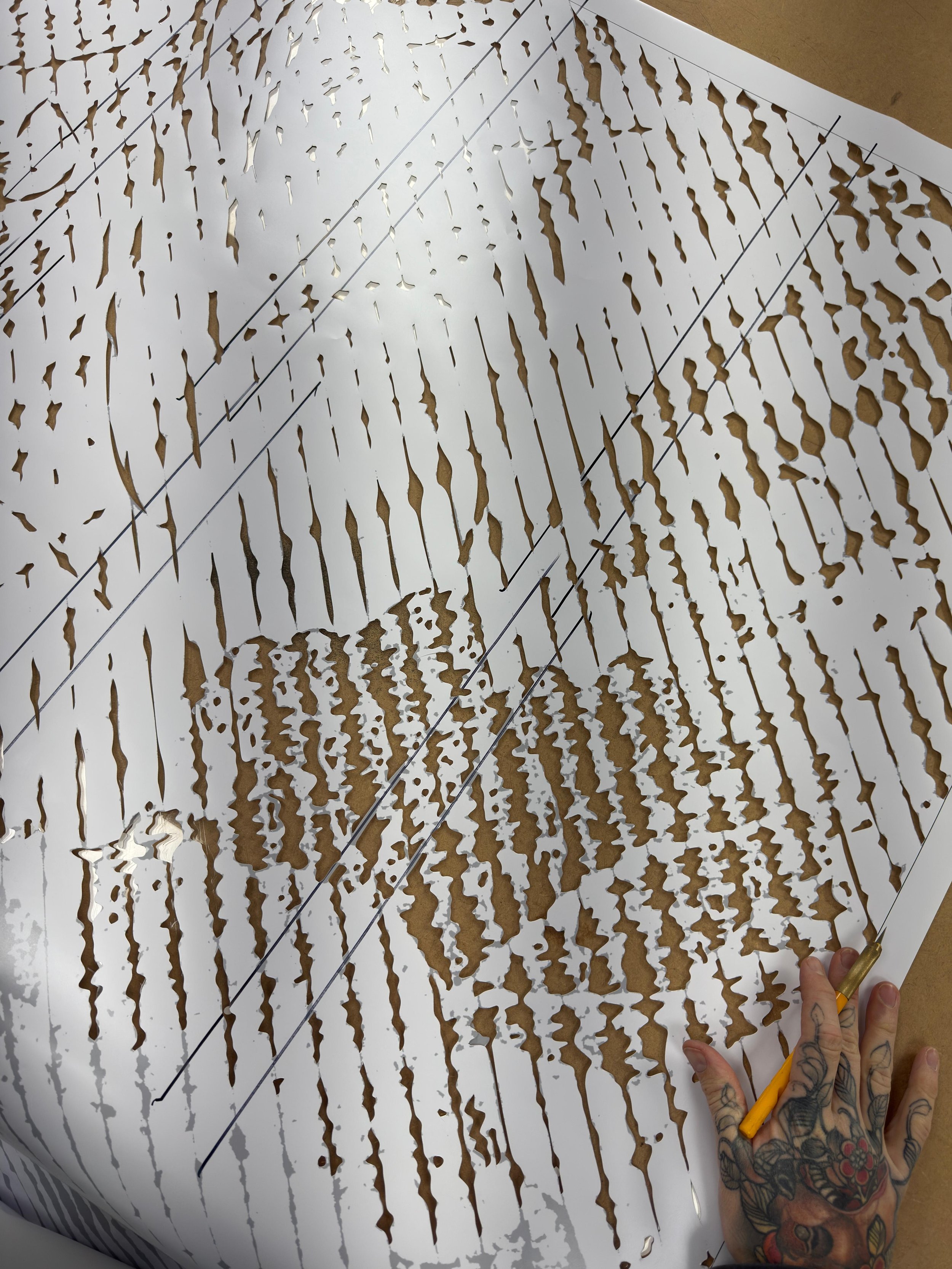 SNIK hand cutting the stencil for New Brighton