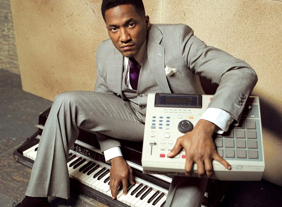 Q-tip from a tribe called quest posing with an mpc conduct magazine