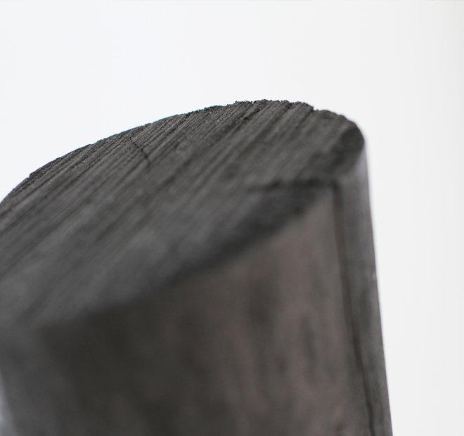 Close-up of textured dark wood used in handcrafted cat furniture