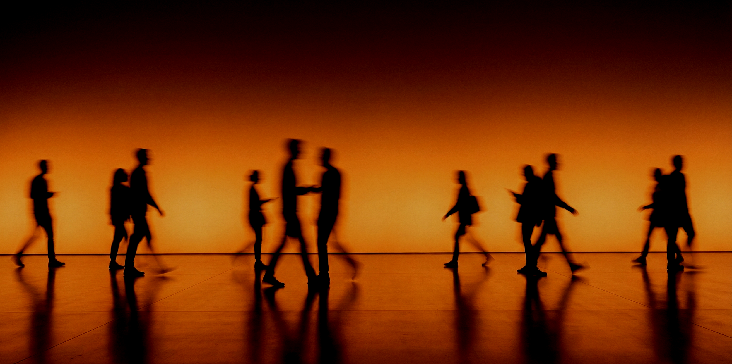 Vietnamese flags with yellow stars and hammer and sickle symbols hanging outside a shop named Fuku Coffee, with people standing nearby and pink flowers overhead.