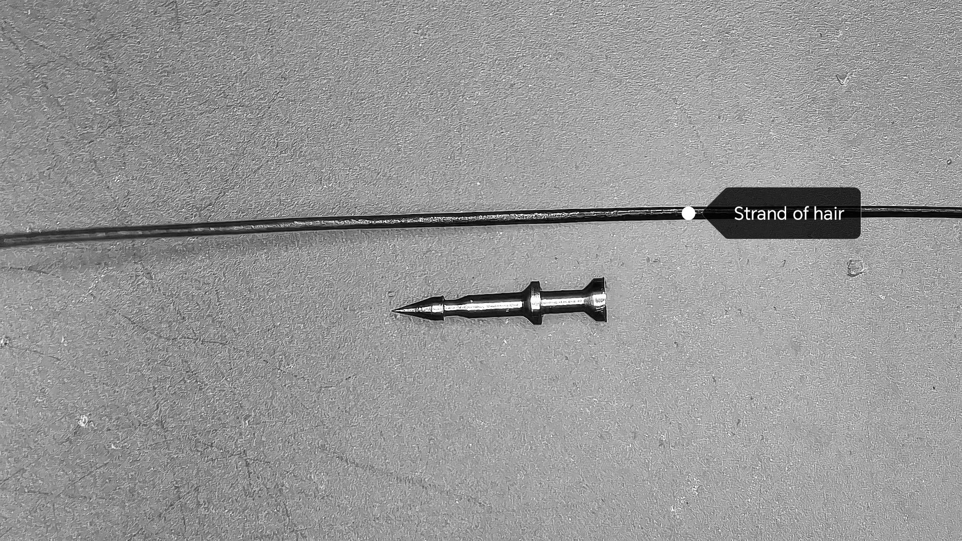extremely tiny manufactured precision part that is about as thick as a strand of hair.