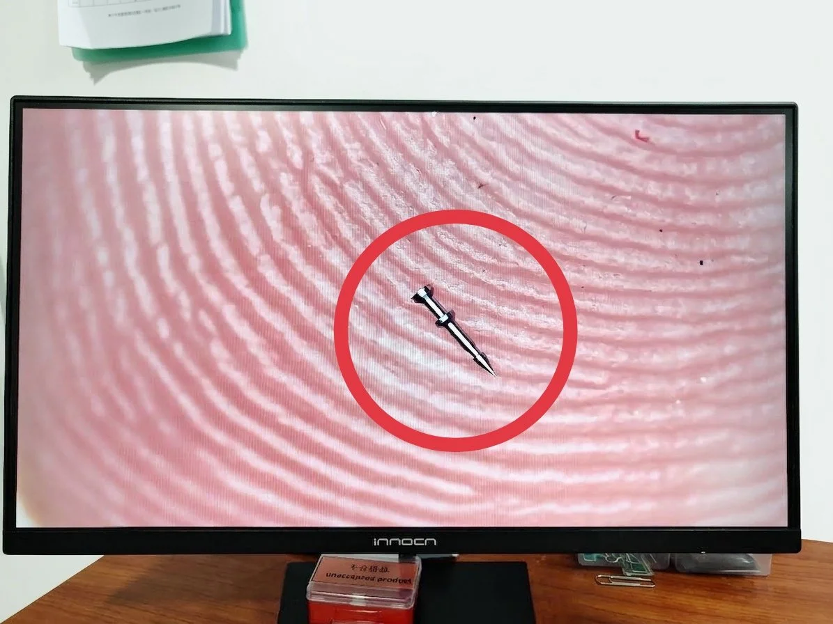 the size of a precision part in comparison to the size of a finger.