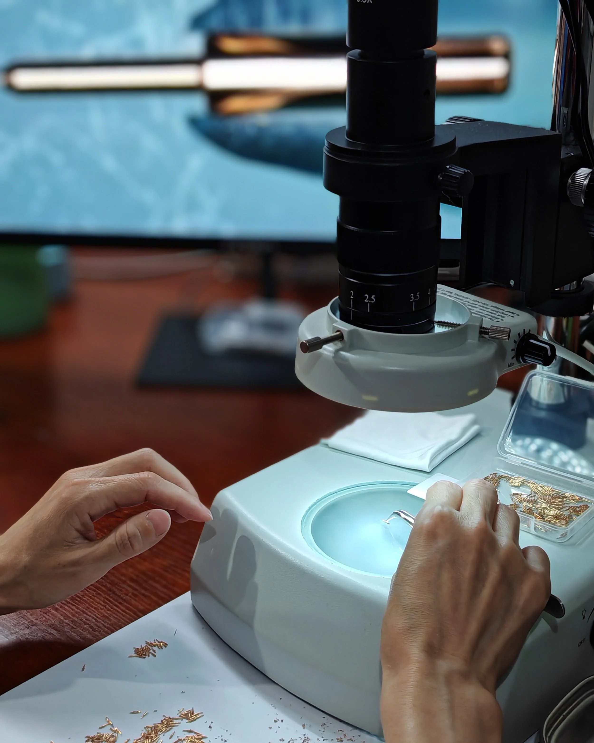 Quality control staff checking for flaws under microscope