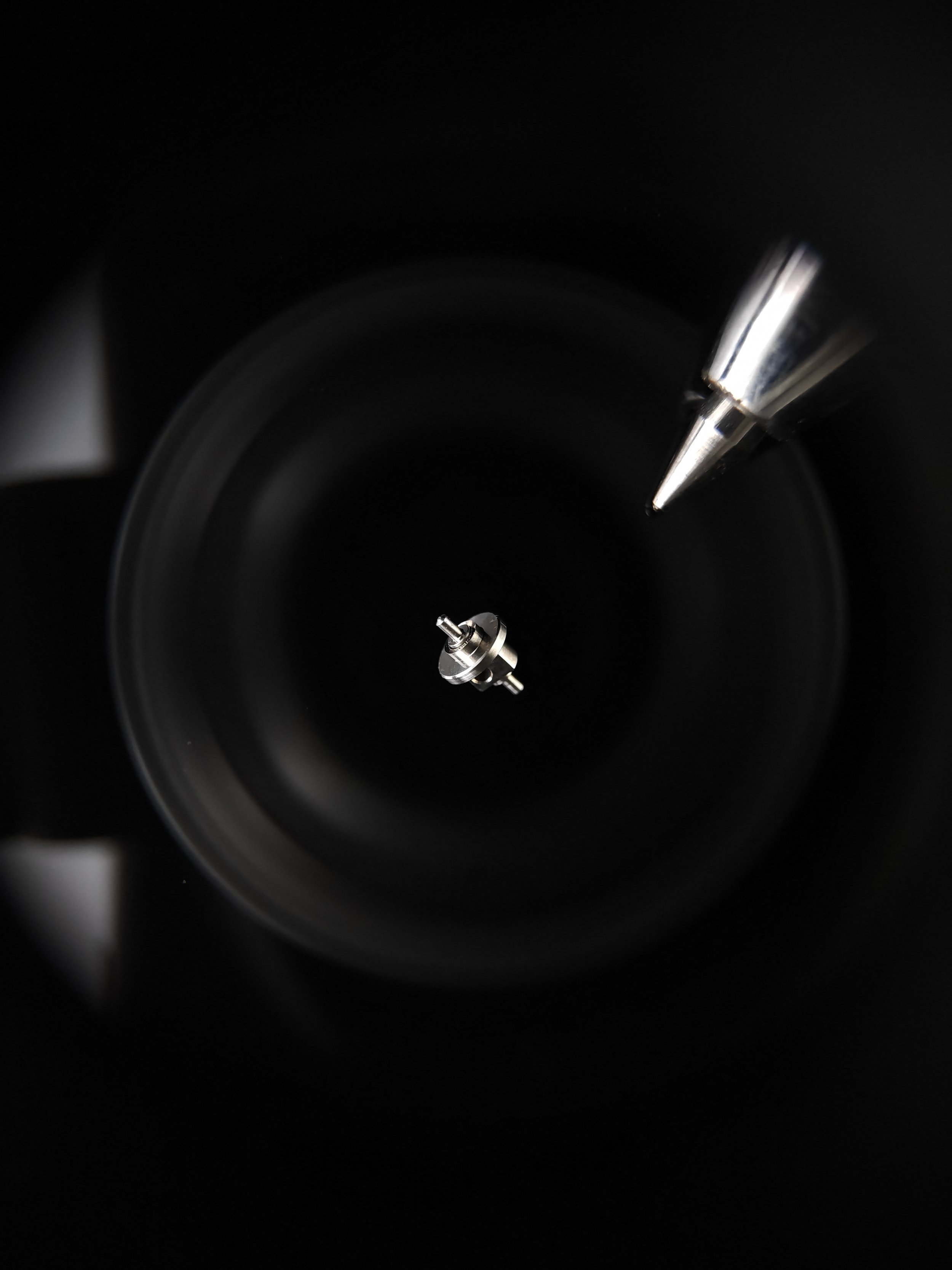 Close-up of a tiny highly precise part with a pen refill