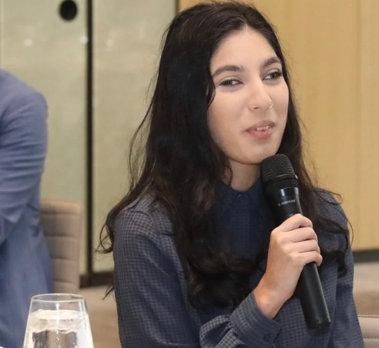 Woman speaking into a microphone