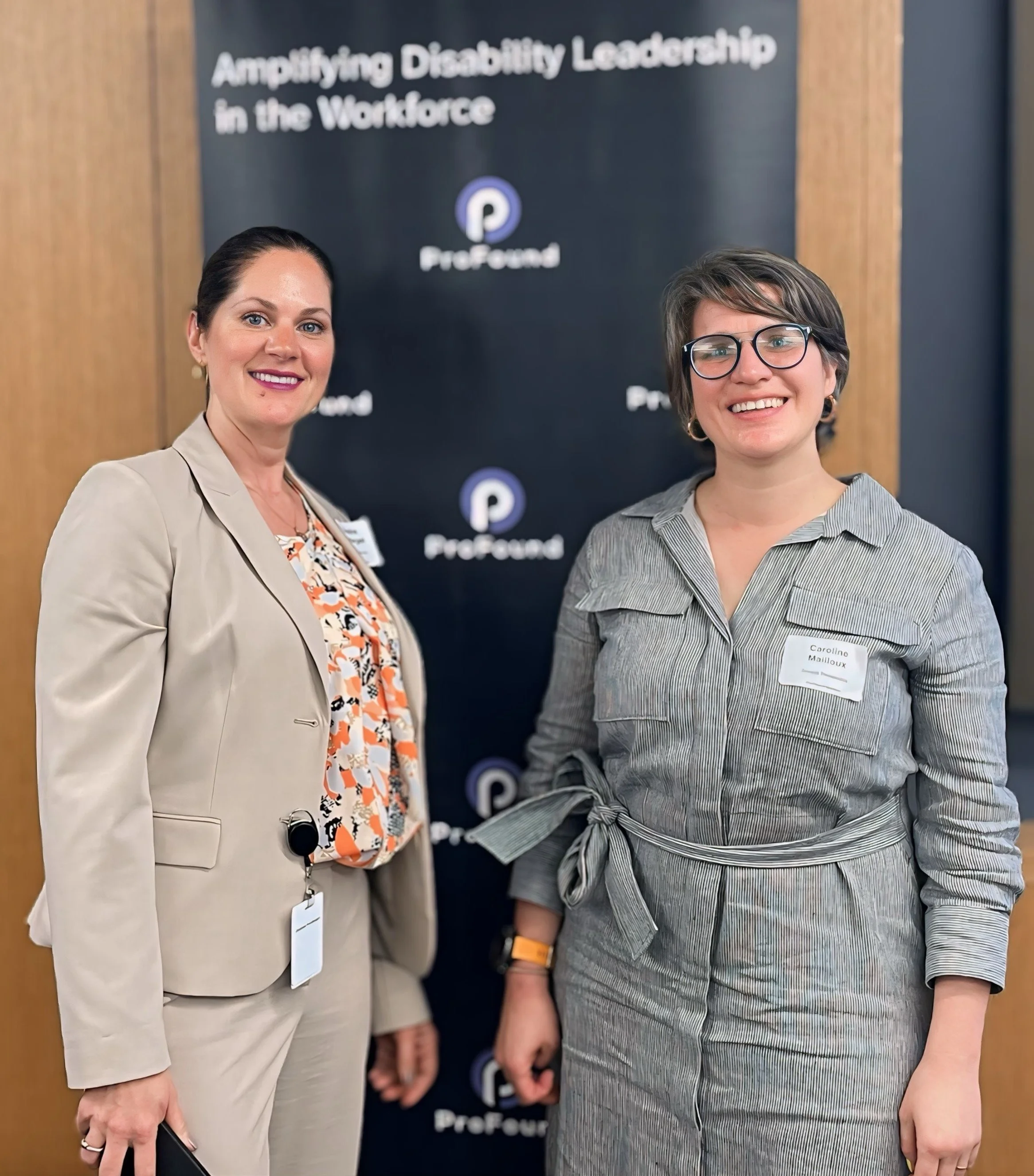Two women smiling in front of a ProFound banner