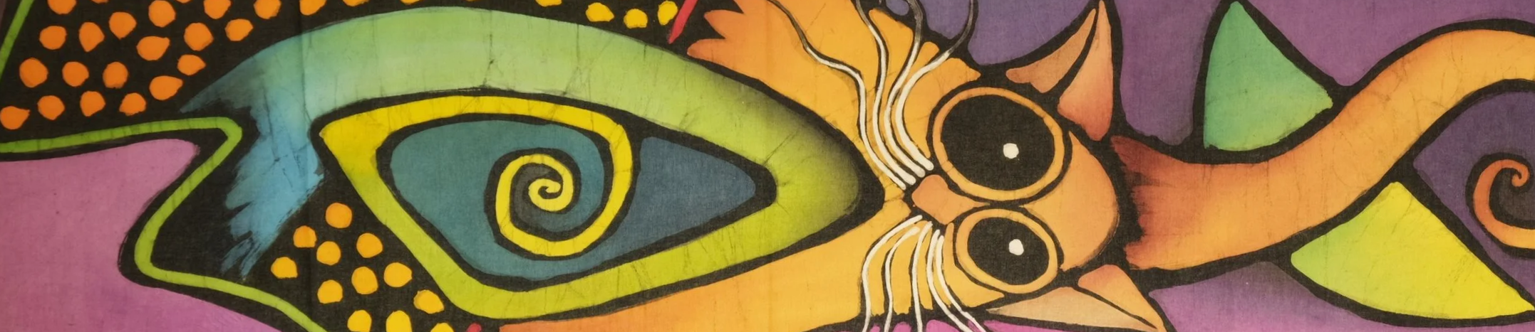 Colorful batik art of a cat with vibrant patterns and a spiral eye design.