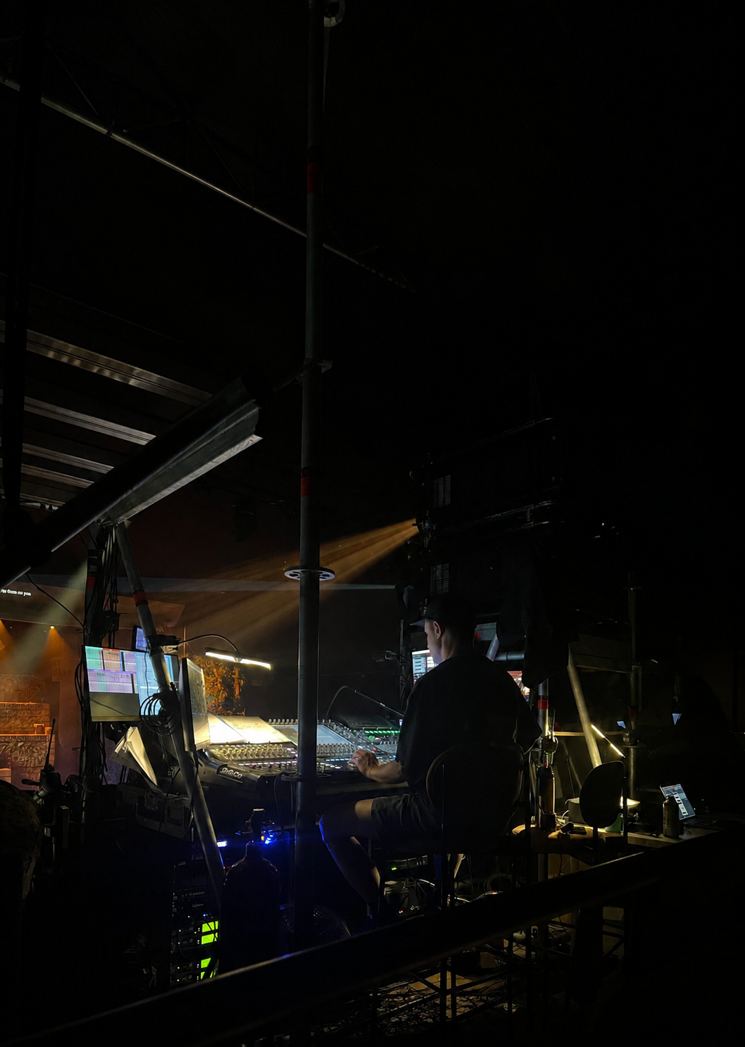 Técnico de sonido operando mezcla en cabina durante una producción en directo
