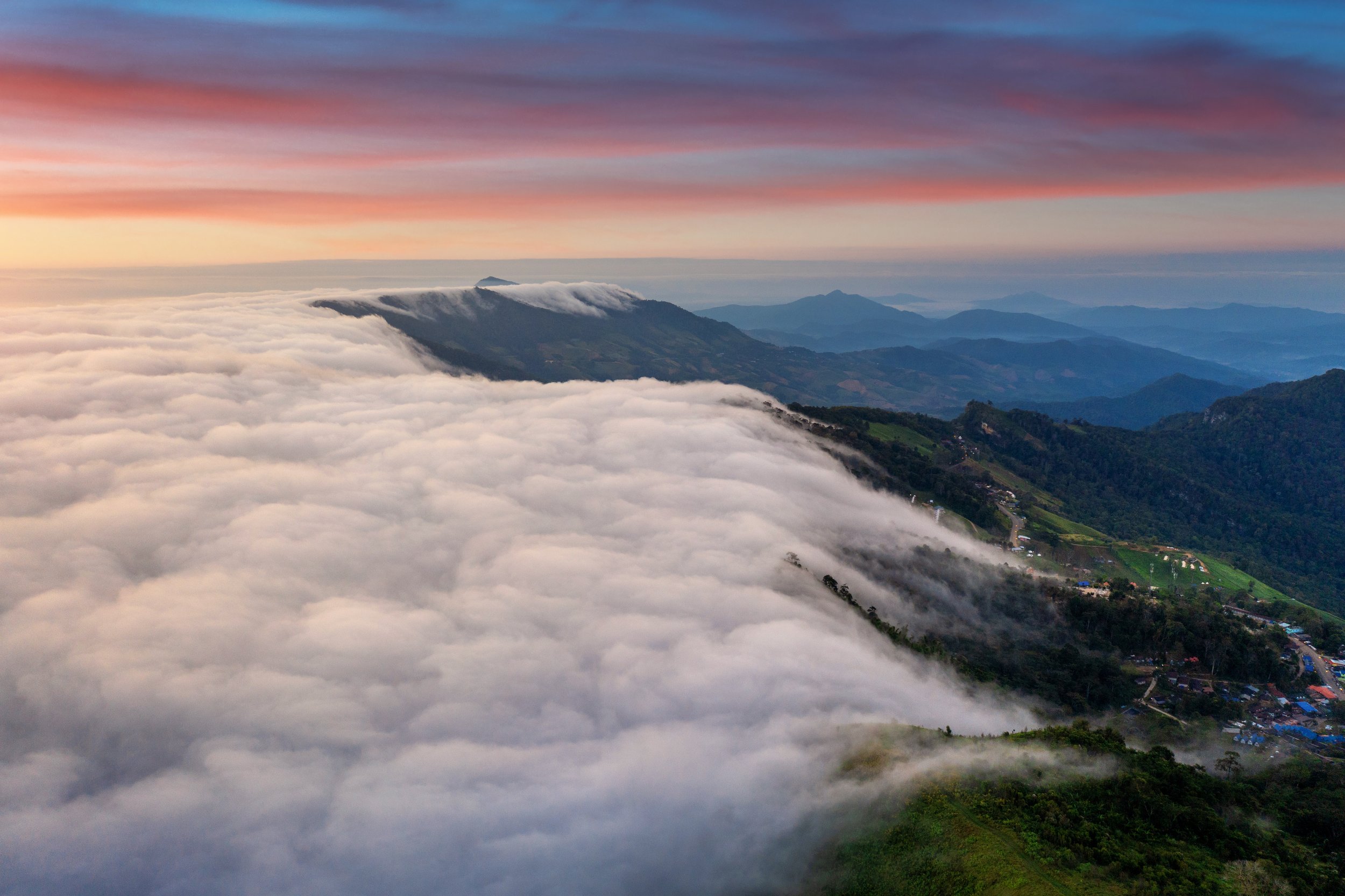 A mountain ridge emerging above a sea of fog at sunrise, revealing how clarity transforms uncertainty into direction.