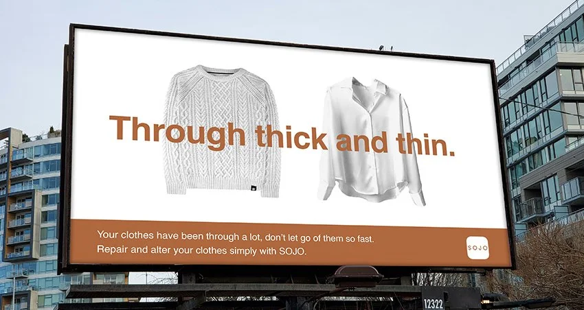 Billboard advertising clothing repair services, featuring images of a thick knitted sweater and a white dress shirt with the text "Through thick and thin" and additional information about repairing clothes with SOJO.