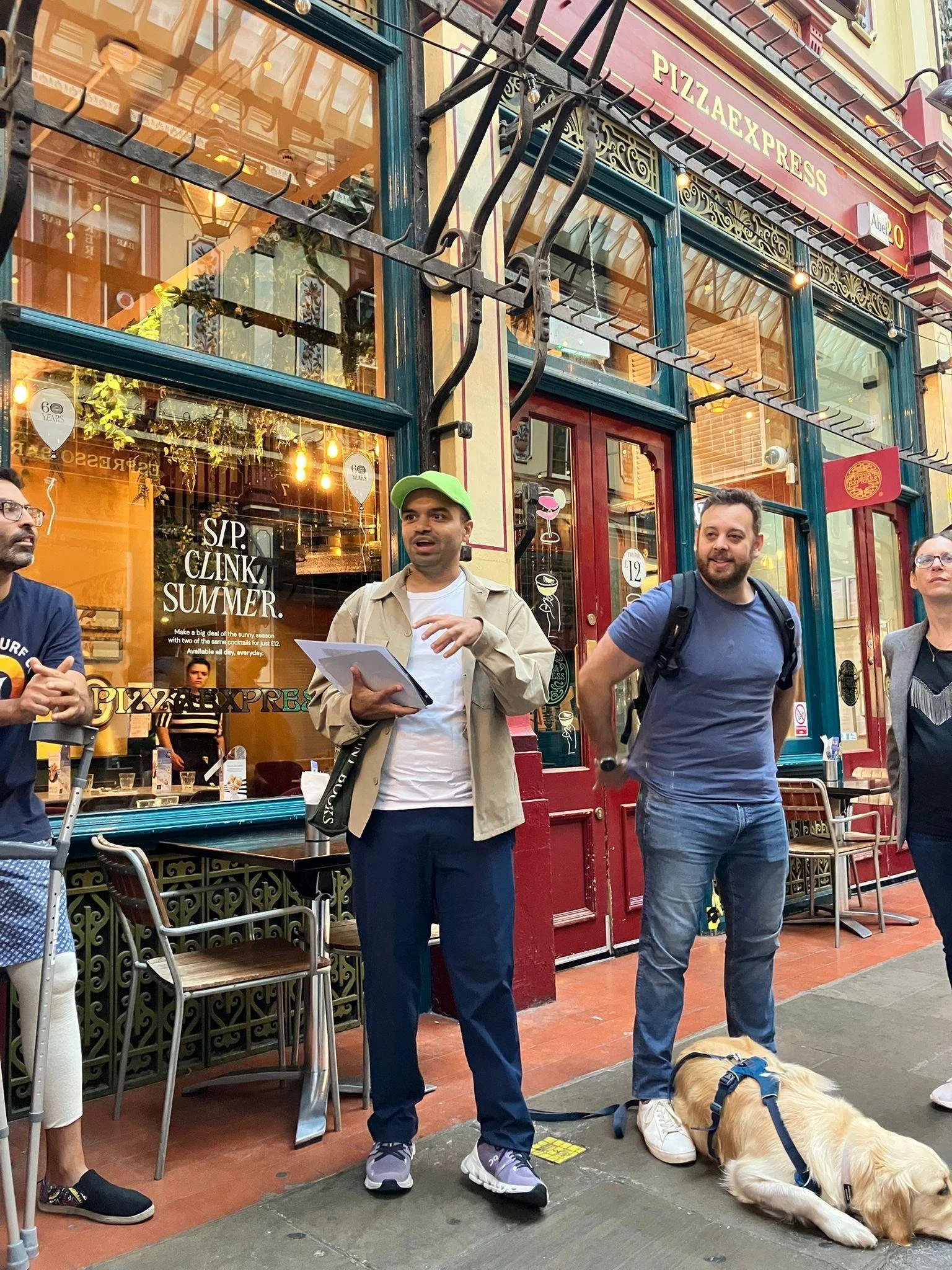 Tour group exploring Leadenhall Market exploring history of the Roman Forum and mercantilism