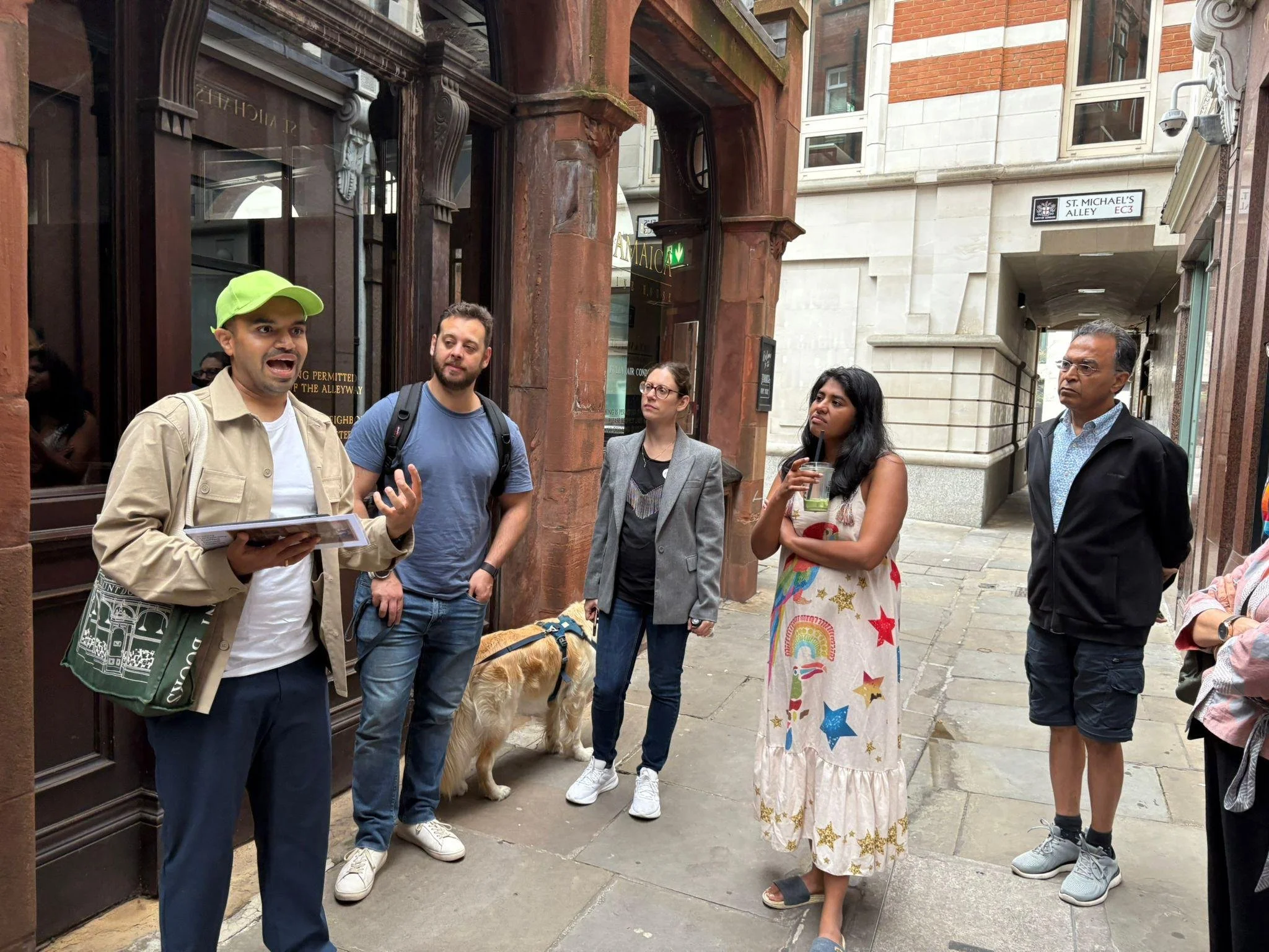 Guide standing outside the historic First London Coffee House at Pasqua Rosee's Head, built in 1652, explaining impact of coffee houses in London