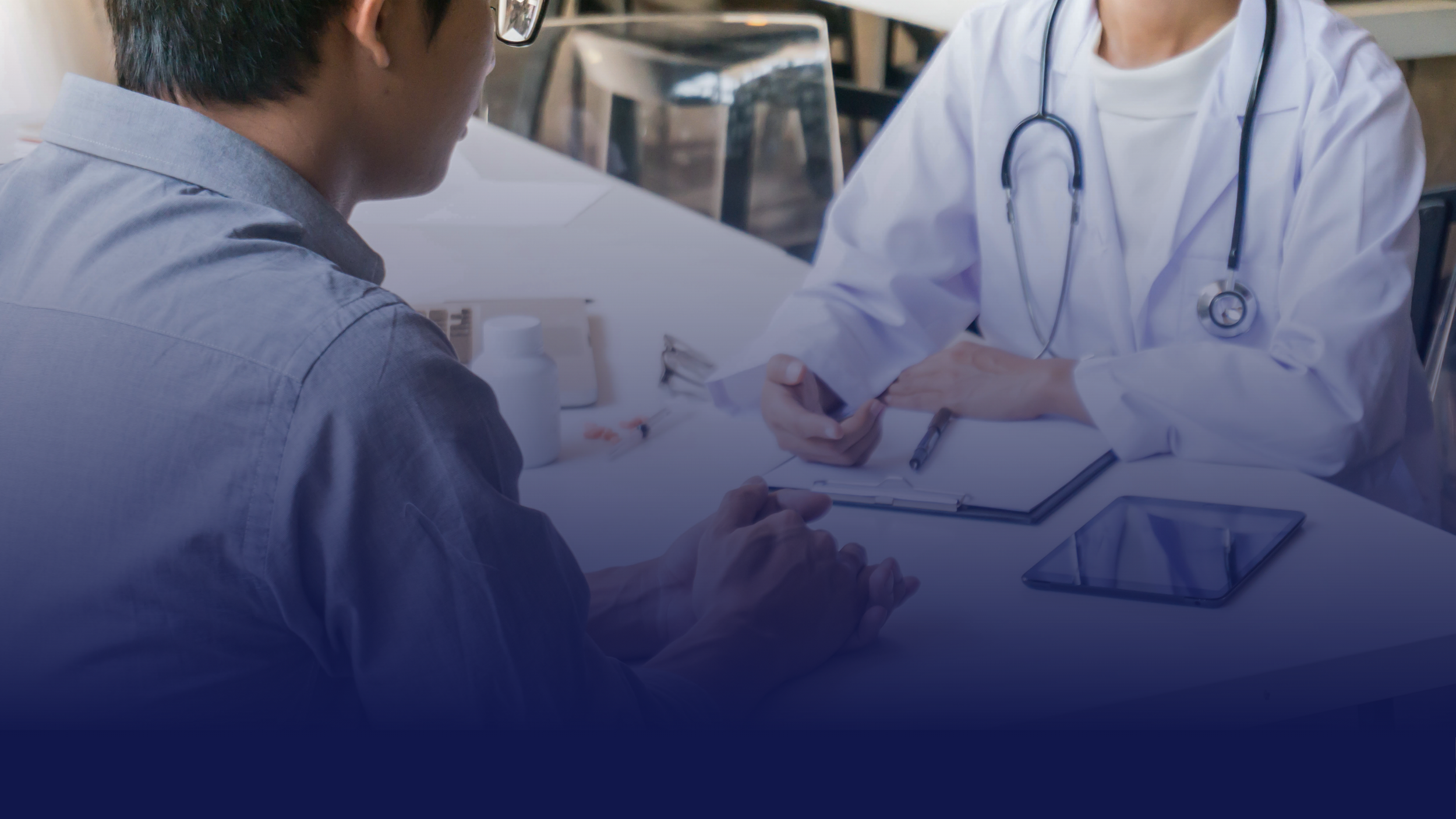 A softly blurred image of professionals collaborating at a table, reviewing documents about joint commission hands-on compliance approach.