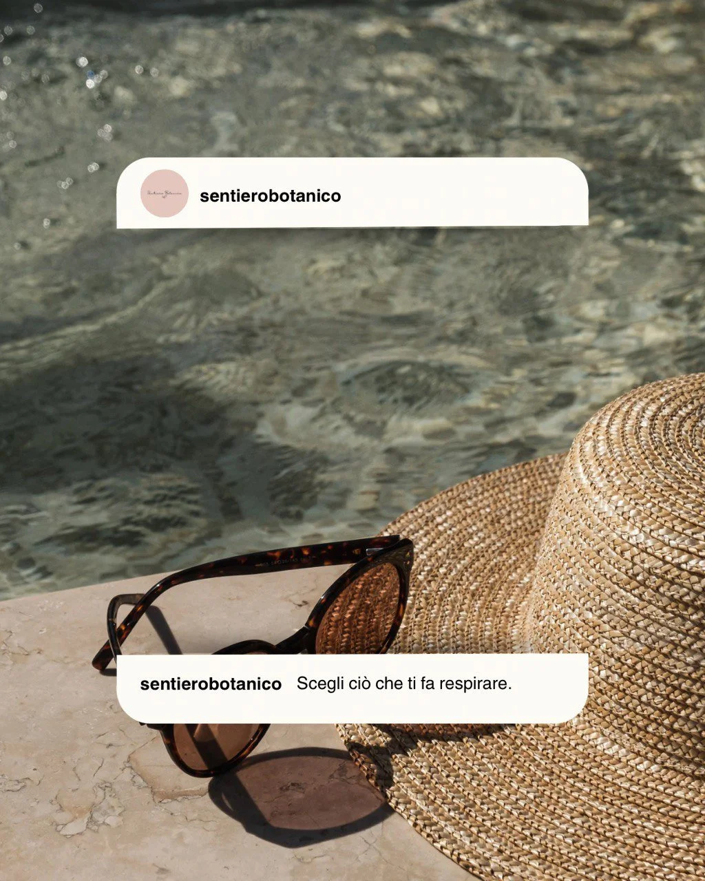 A straw sunhat and sunglasses resting on a stone surface by the water, with Instagram comments overlaid.