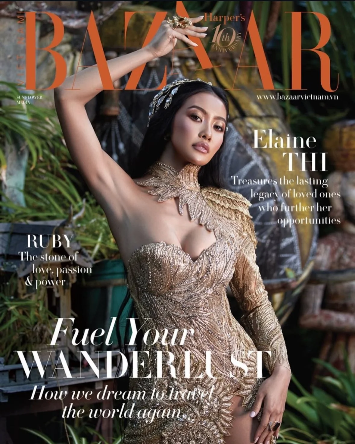 Close-up of a woman in an ornate gold dress on the cover of Harper's Bazaar Vietnam magazine, with greenery in the background.