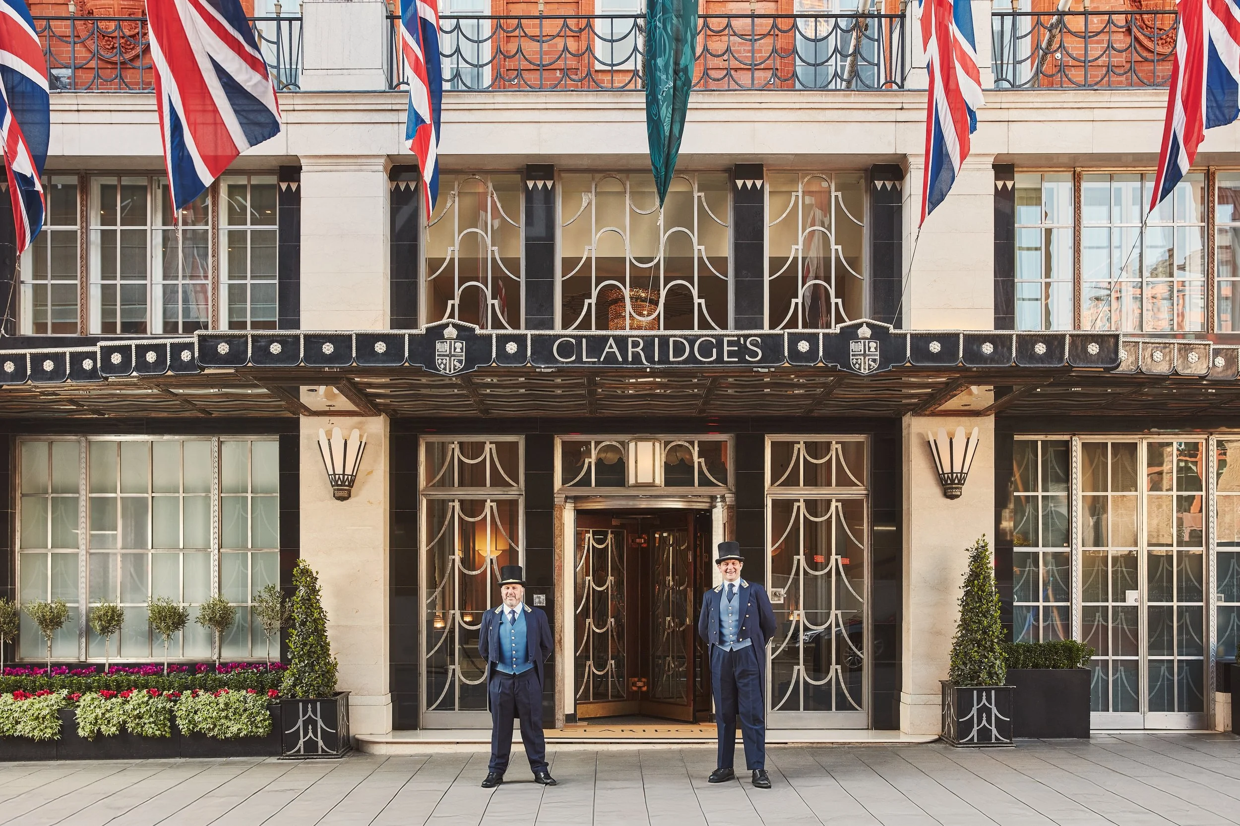 The exterior of Claridge's Hotel London with two uniformed doormen standing at the entrance